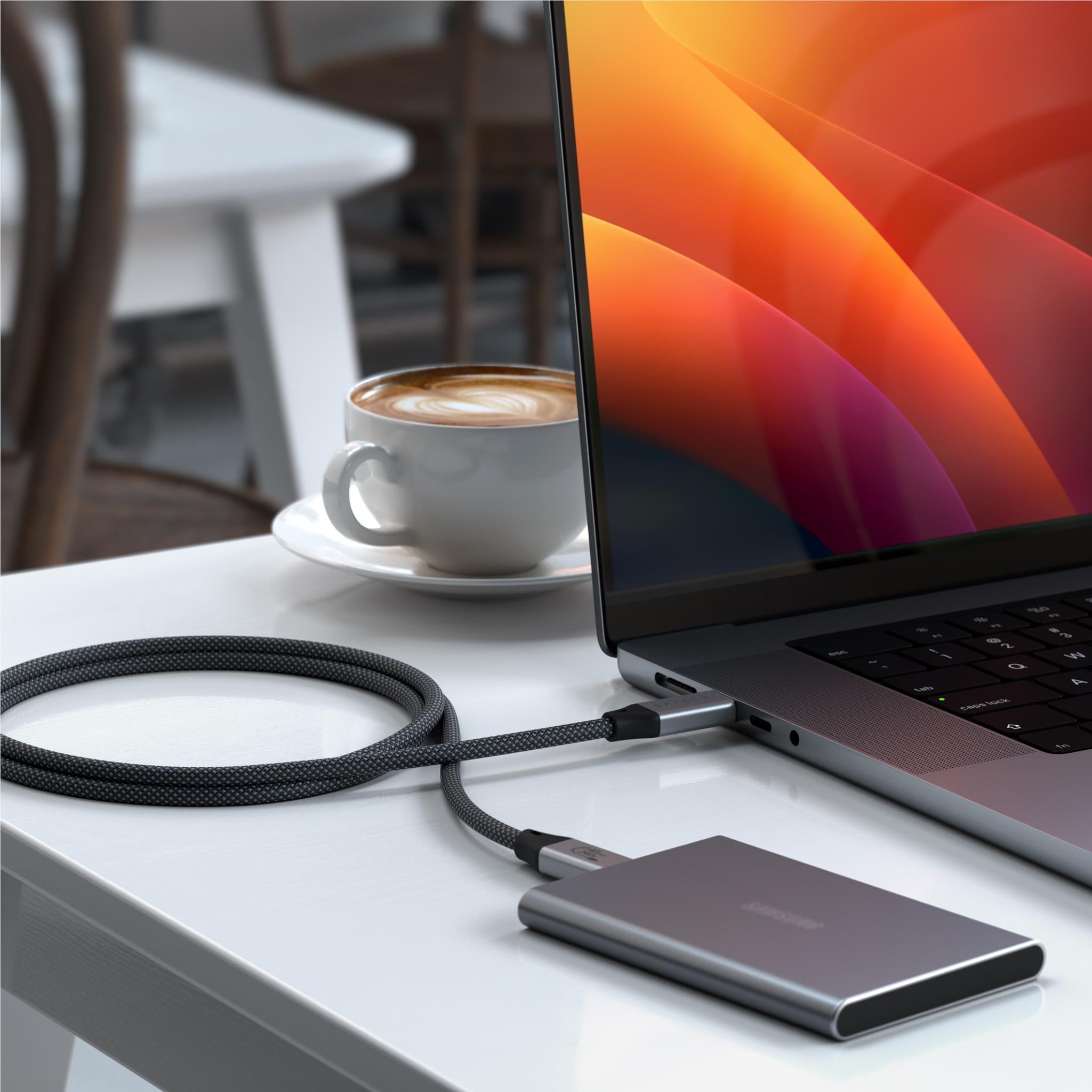 USB-C to USB-C cable connected to laptop and external drive with black braid