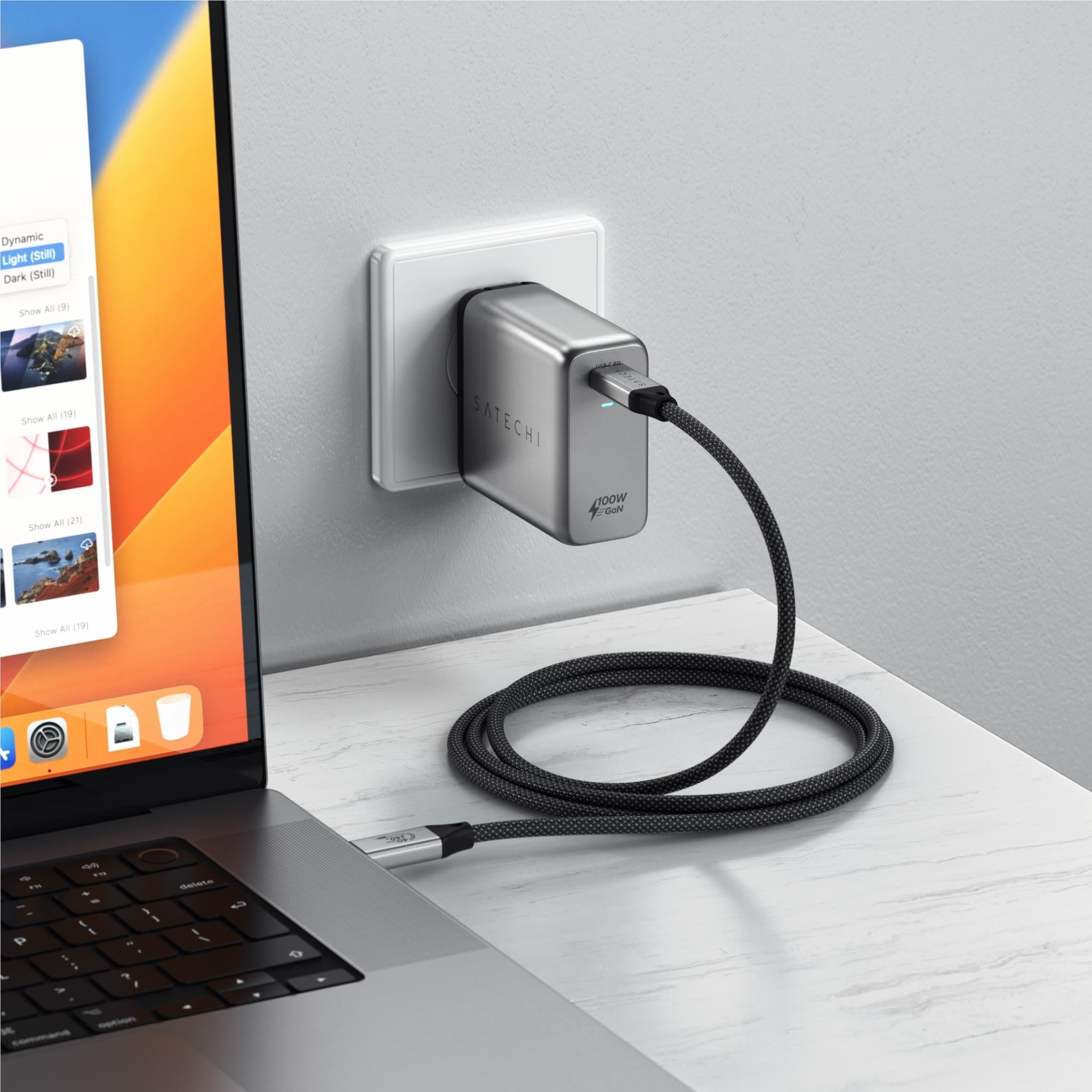 USB-C to USB-C cable plugged into a wall outlet adapter with black braided cable