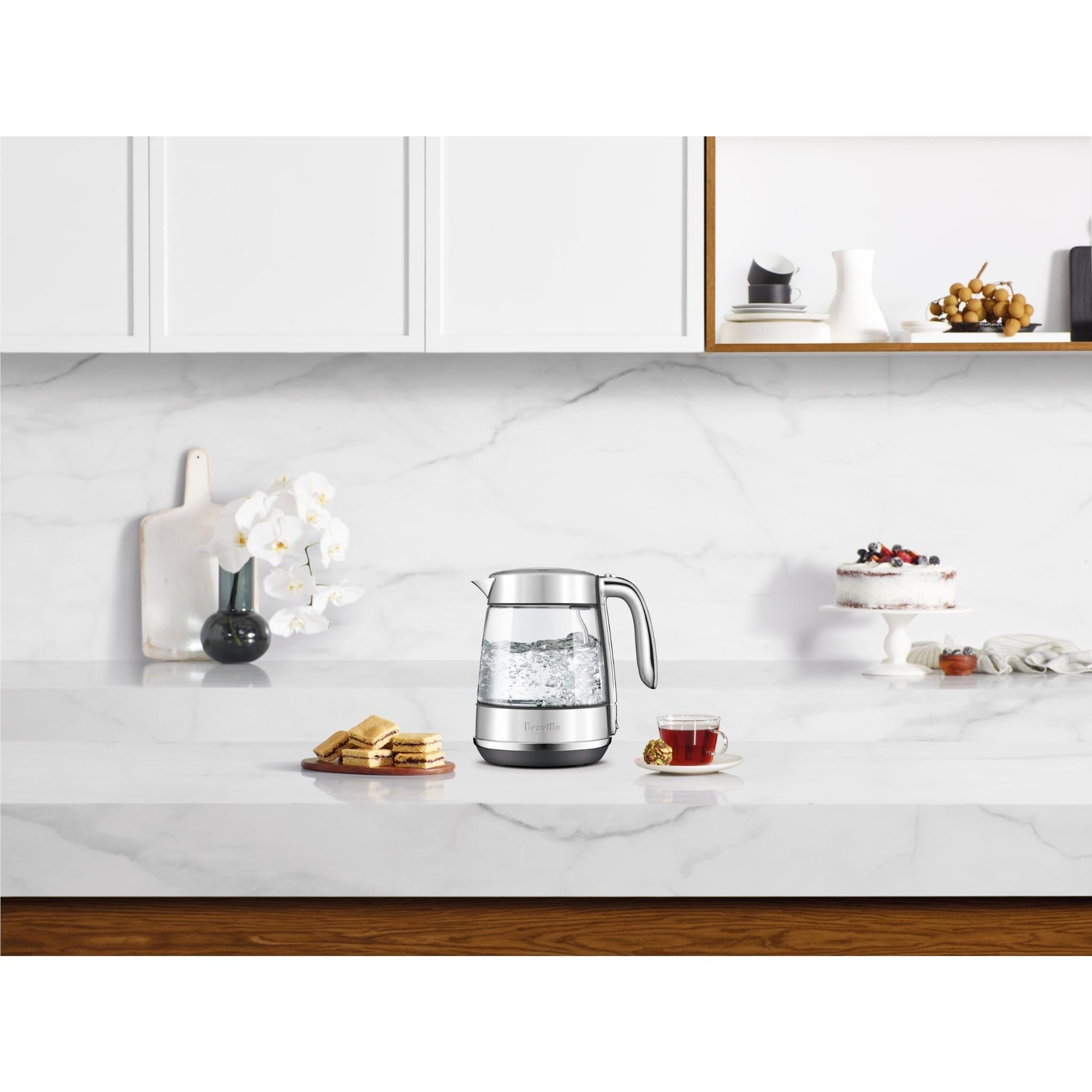 Breville glass jug electric kettle on kitchen counter with clear water level and silver handle