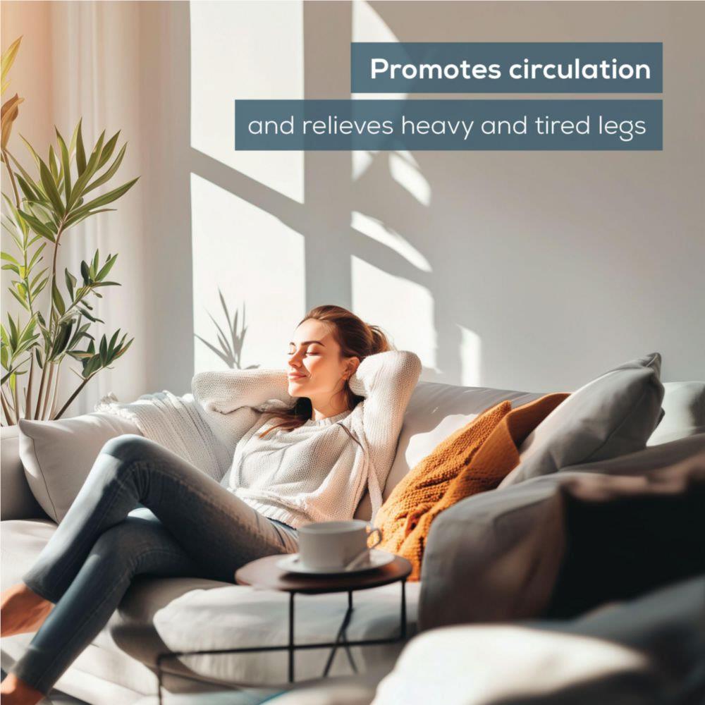 Grey foot massager cushion used on couch while seated for leg relief