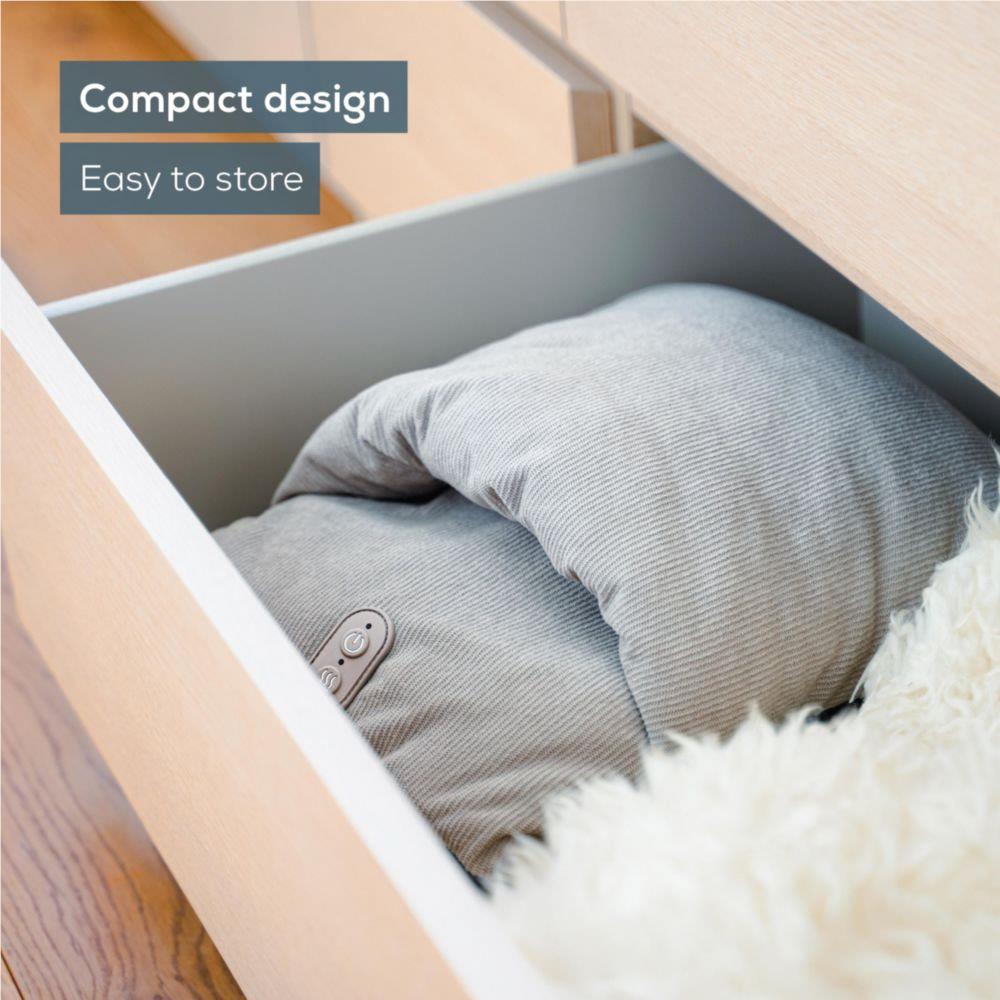 Grey foot massager cushion stored in a drawer for compact, easy storage