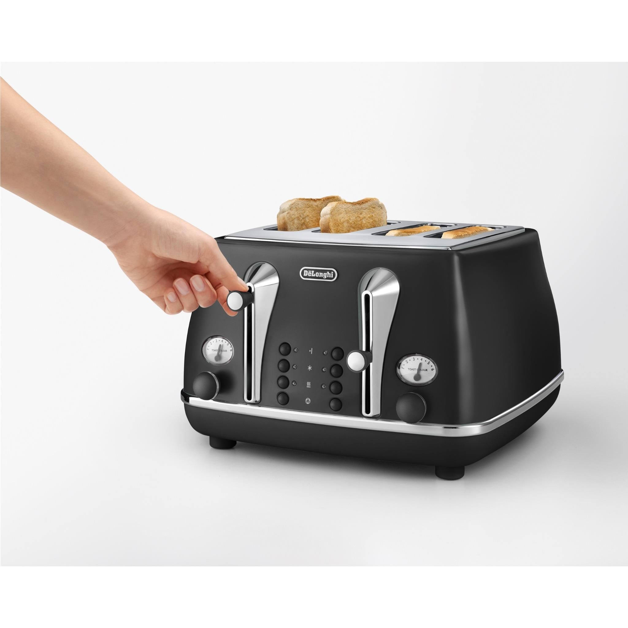 Black 4-slice toaster with hand placing bread into the slots
