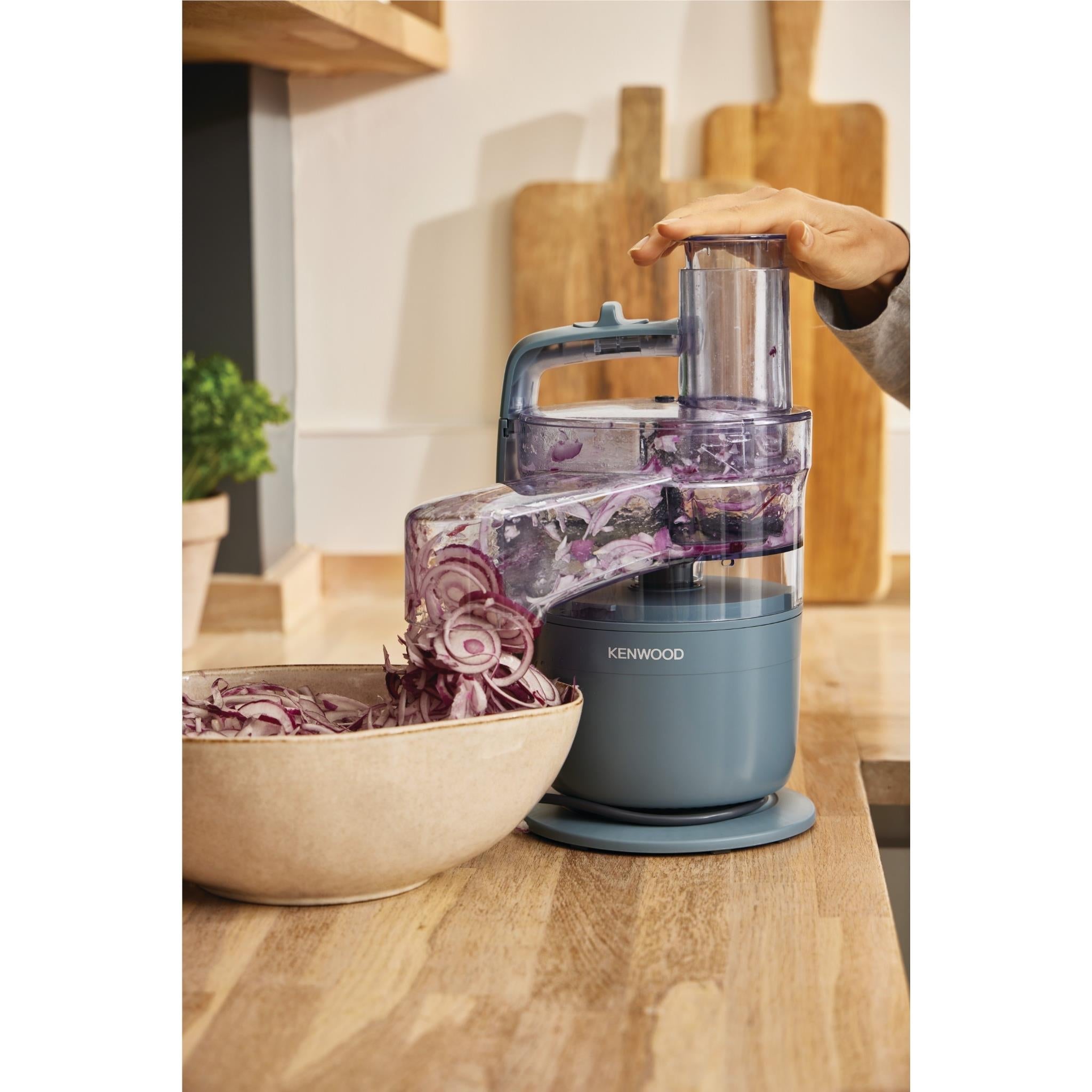 Storm Blue food processor with clear jug being used to chop mixed ingredients