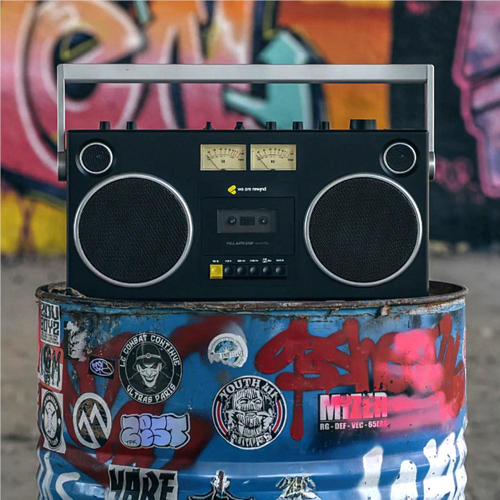 Black cassette boombox on graffiti drum with dual speaker grilles