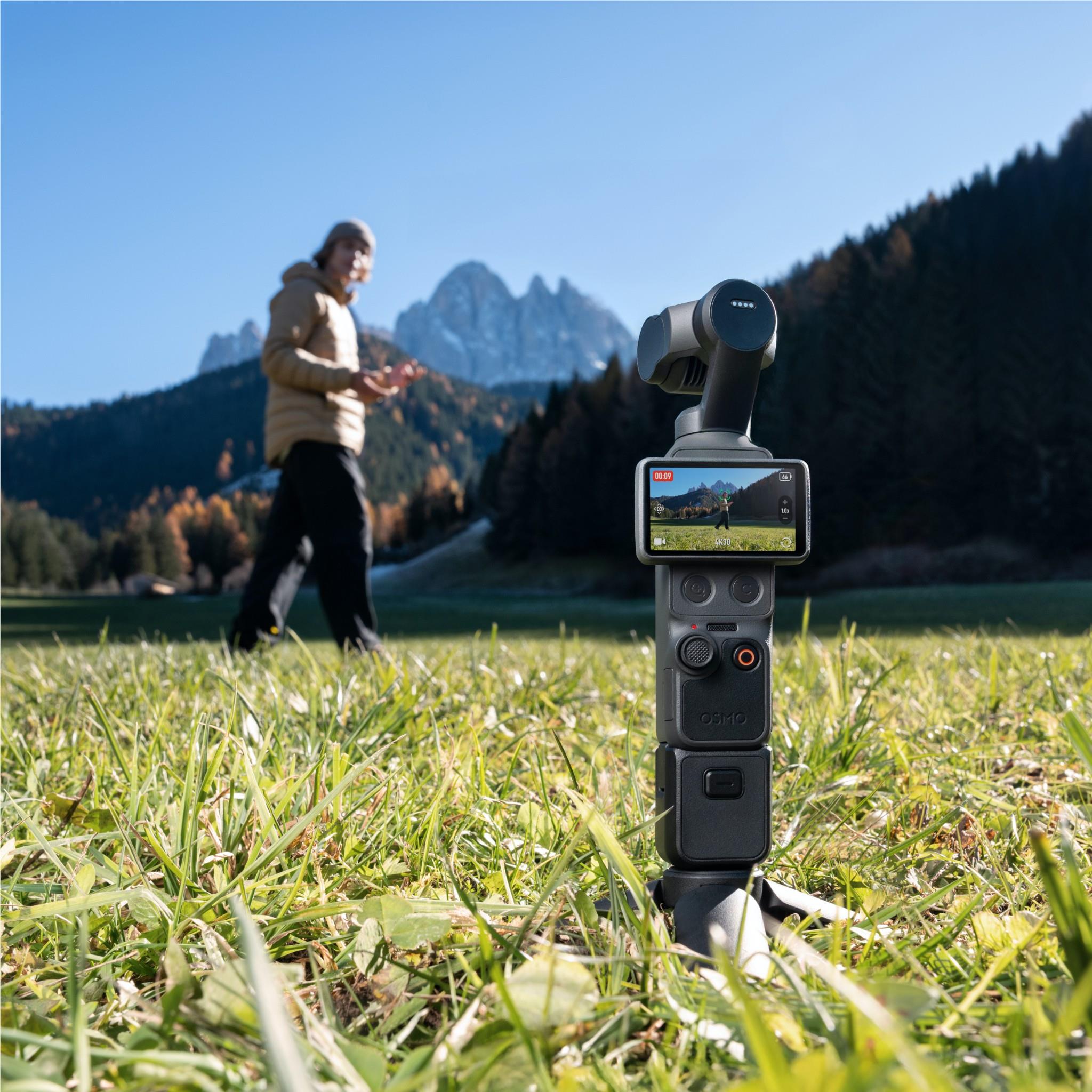 Handheld gimbal camera on stand with touchscreen and joystick controls, black