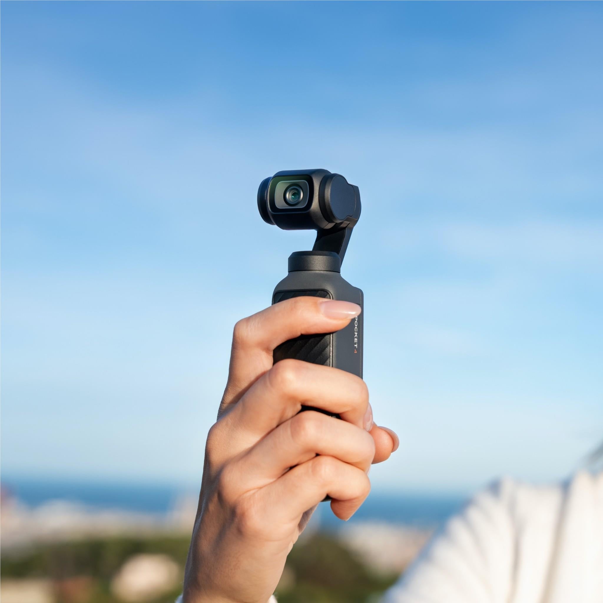 Black gimbal camera held vertically with front lens and joystick controls