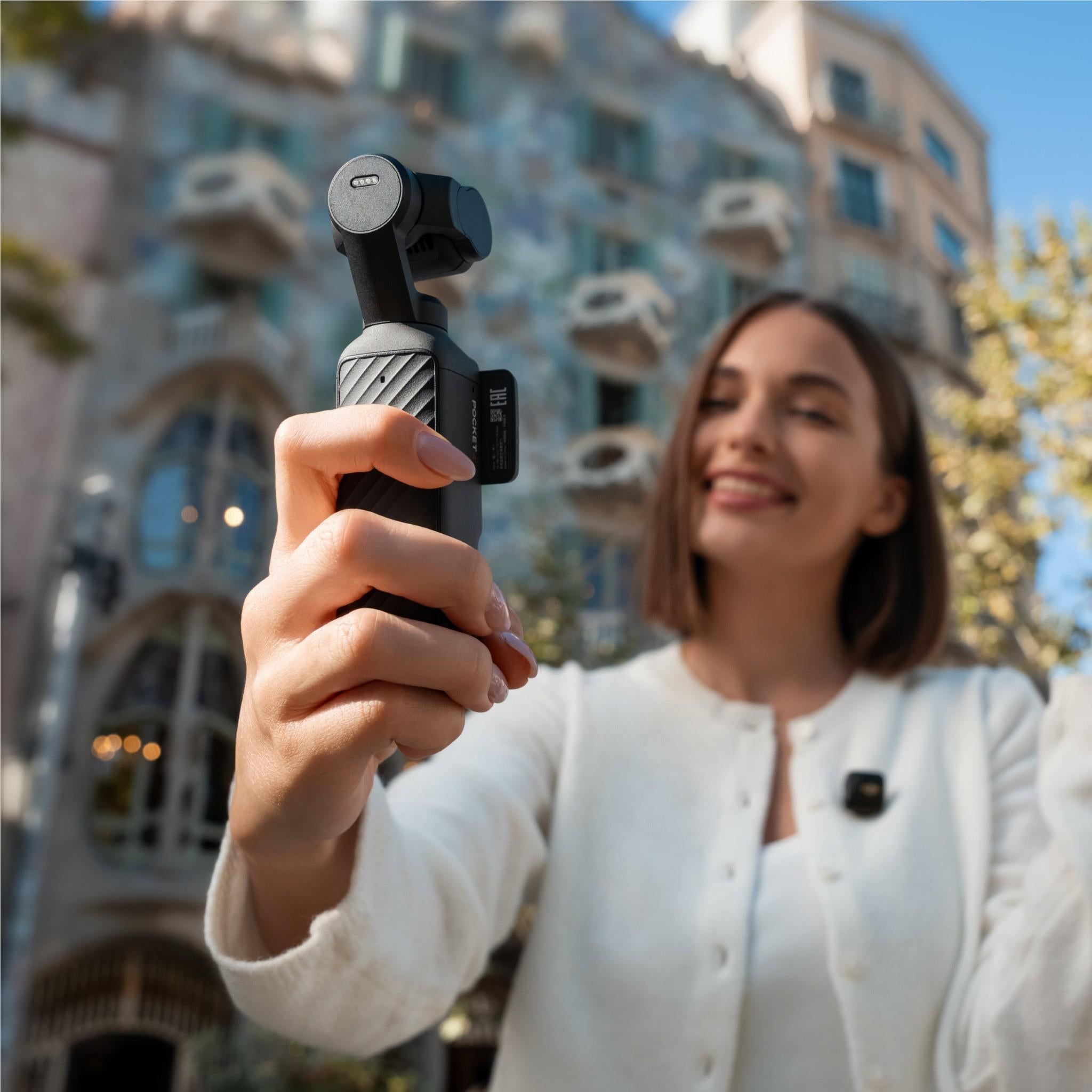 Handheld gimbal camera with lens module and side control buttons, black