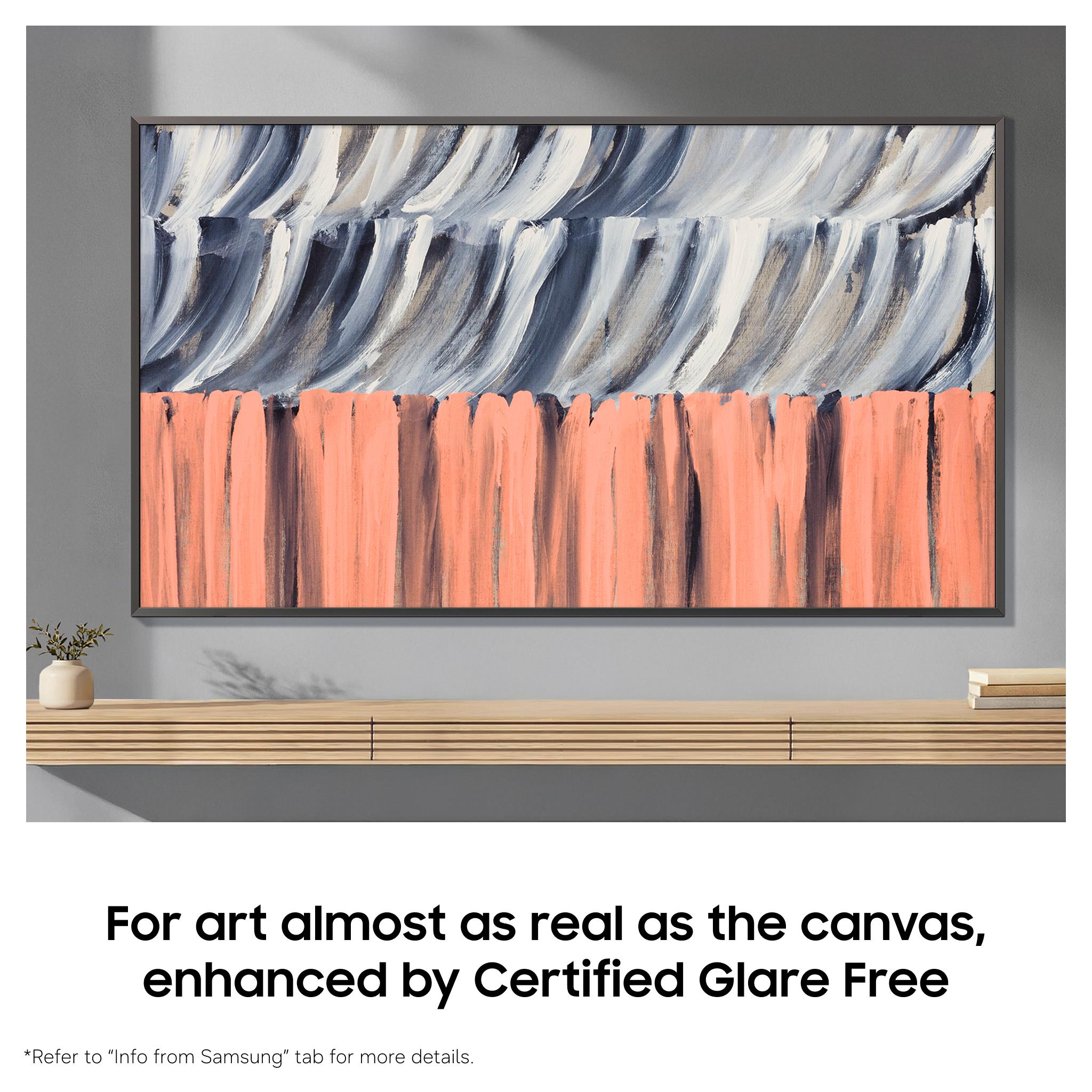 Framed Samsung QLED TV with abstract blue and coral artwork on display