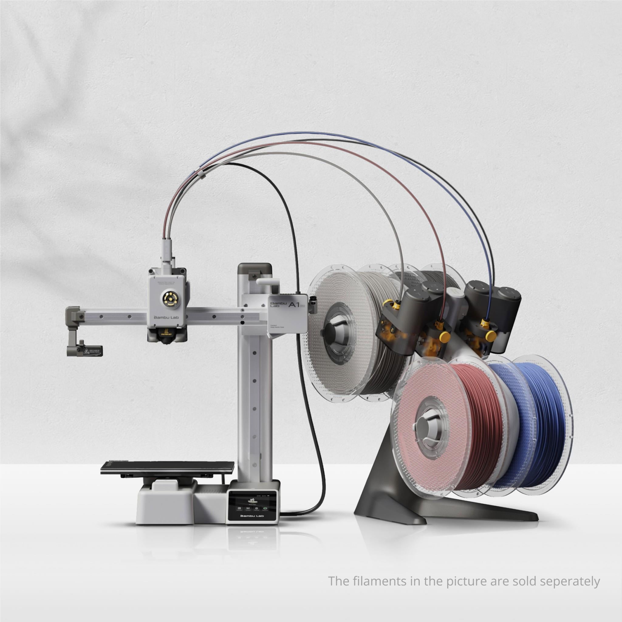 Compact desktop 3D printer with filament spools on angled holders