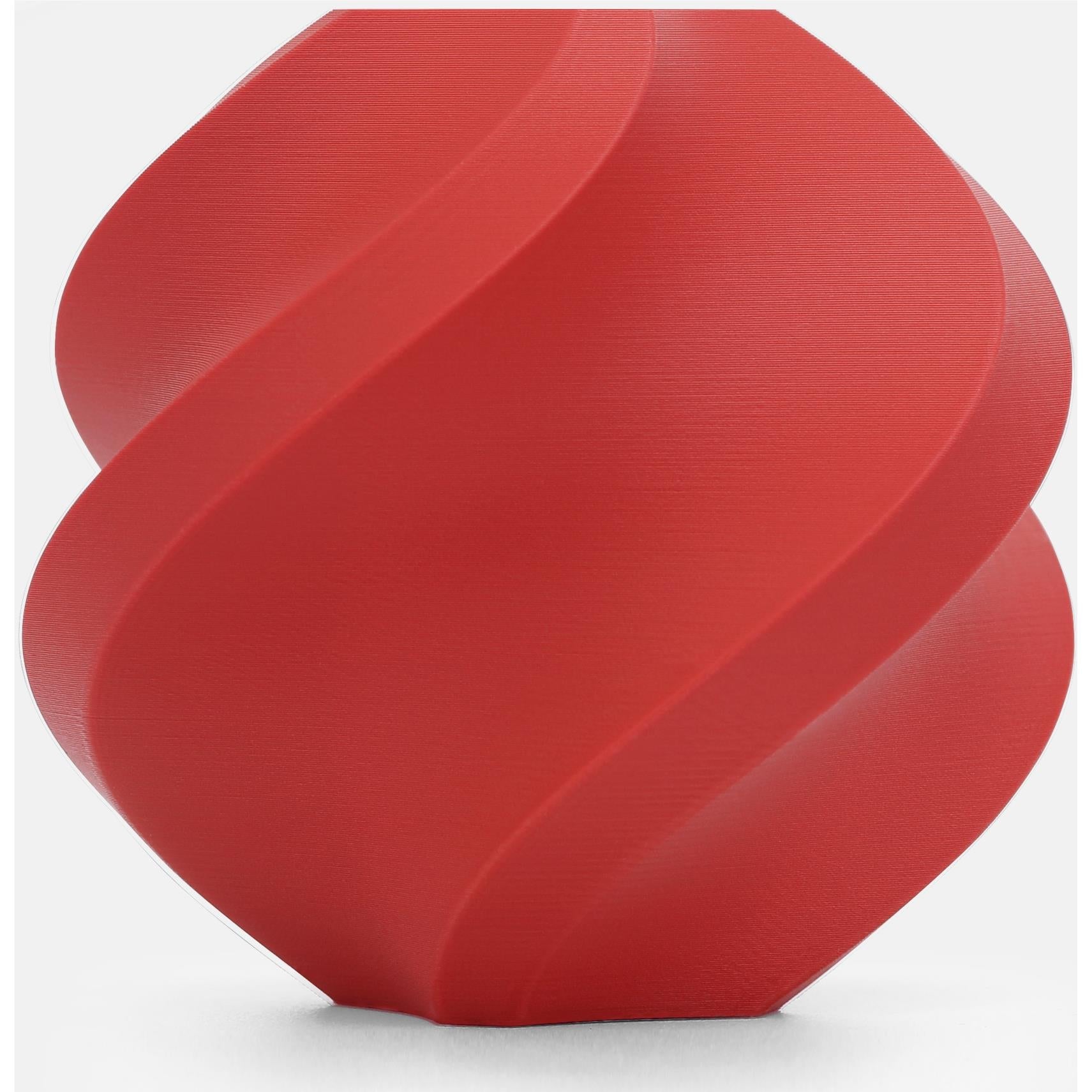 Matte scarlet red PLA 3D printer filament spool, close-up of coiled layers