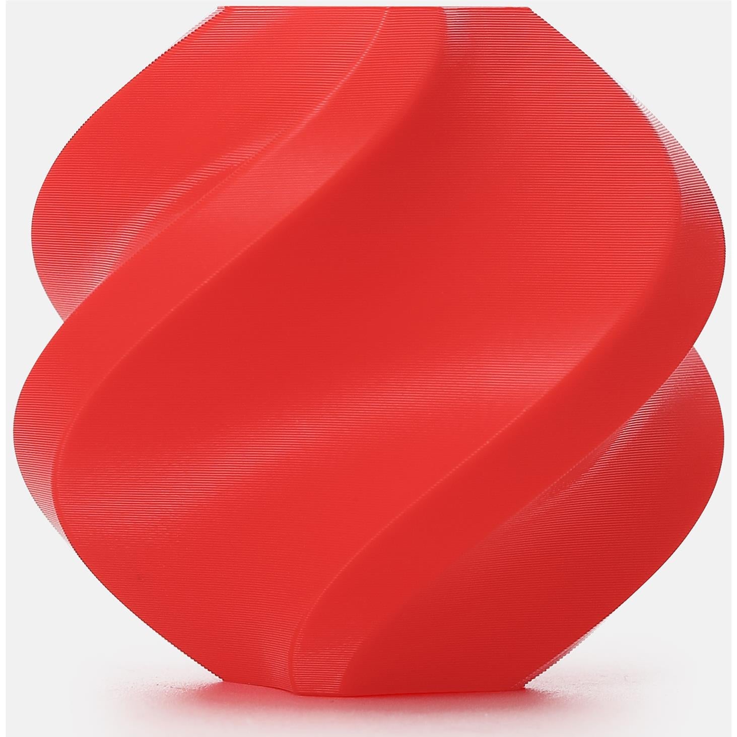 Red PETG 3D printer filament spool with tightly wound coiled strand