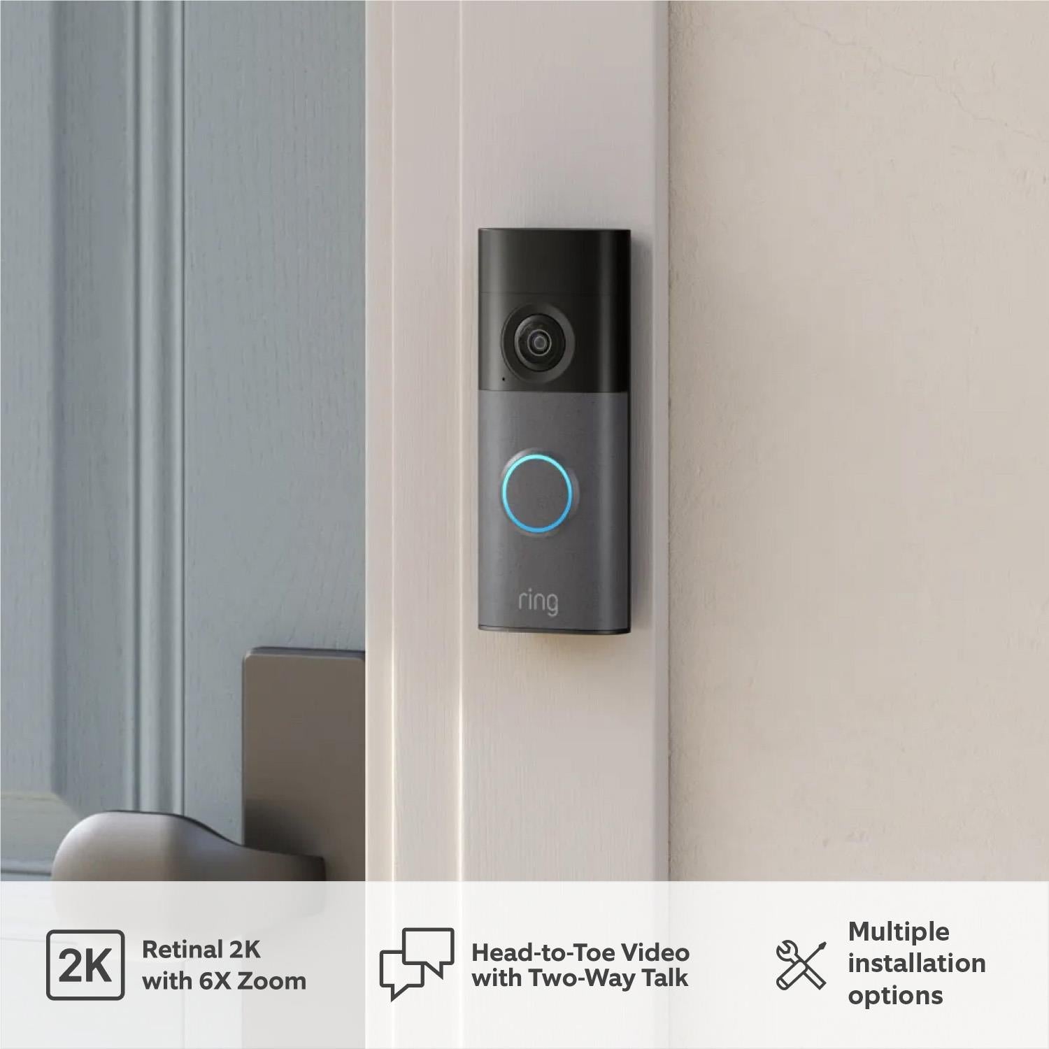 Speckle gray video doorbell mounted on wall with glowing blue ring
