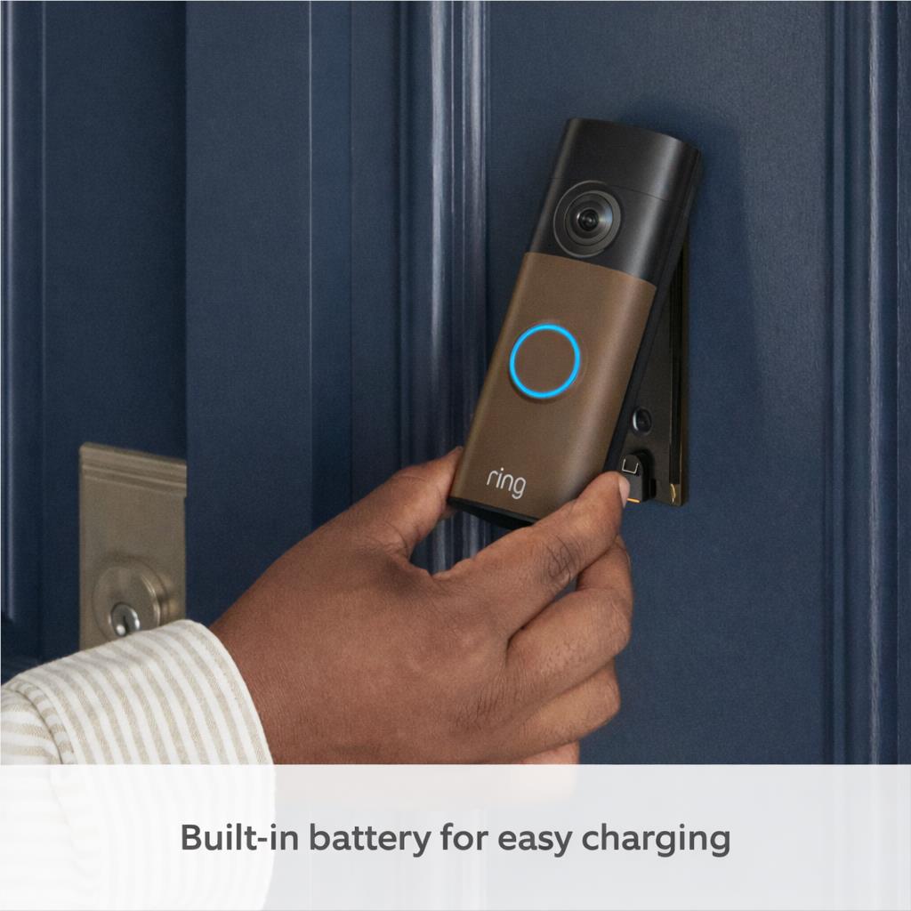 Hand holding matte mocha battery video doorbell on wall with blue ring light