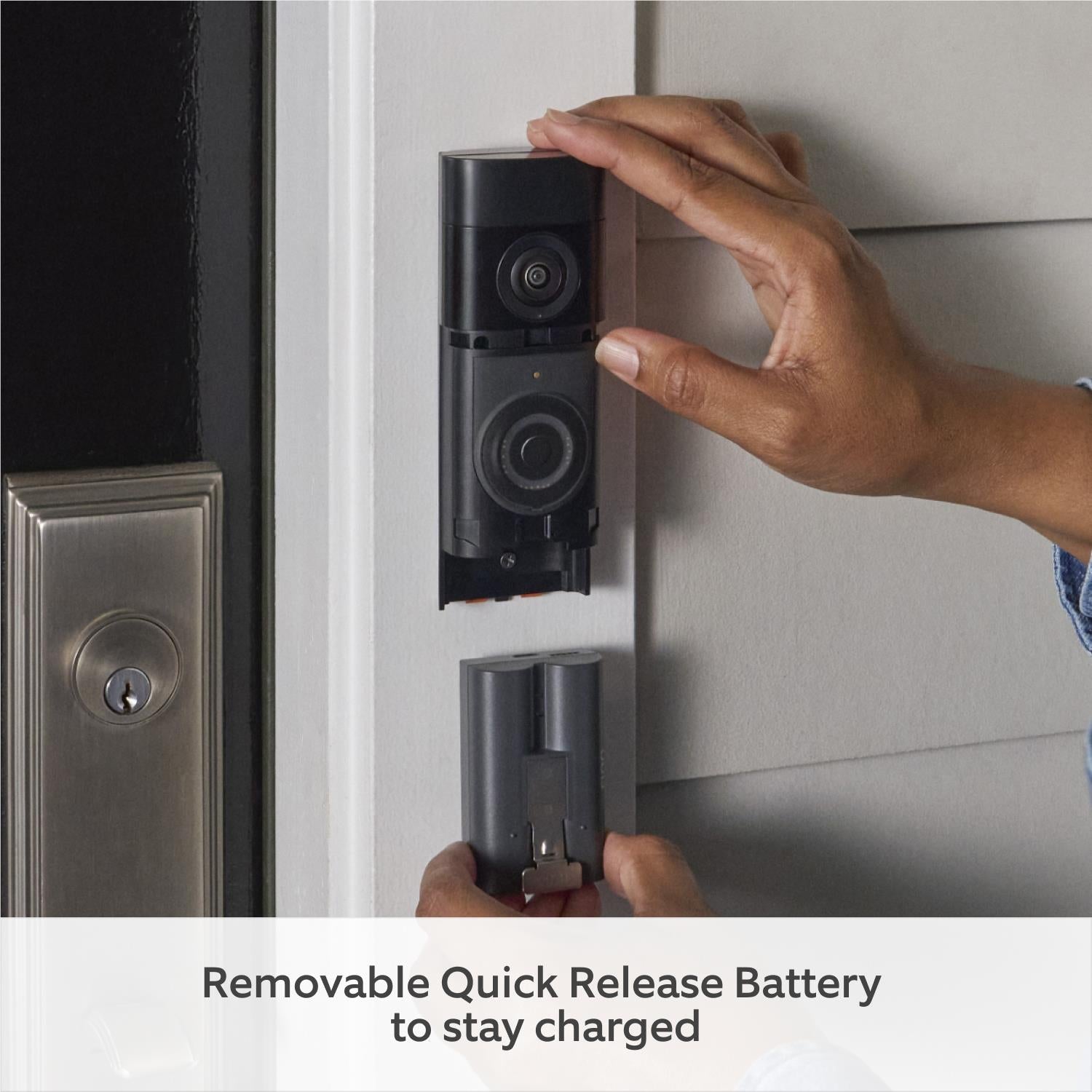Hand pulling out a removable battery from the back of a video doorbell