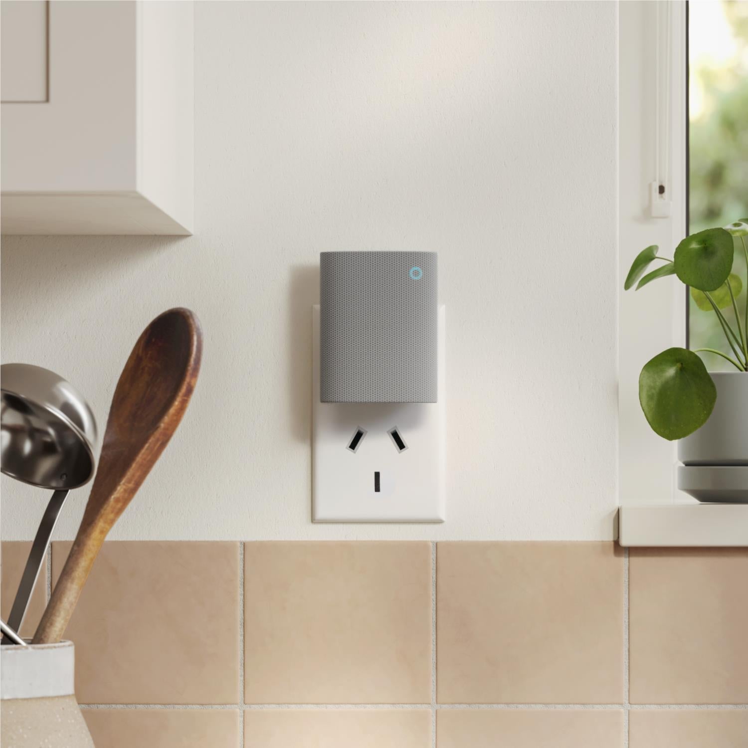 Gray plug-in indoor doorbell chime mounted on wall with blue indicator light