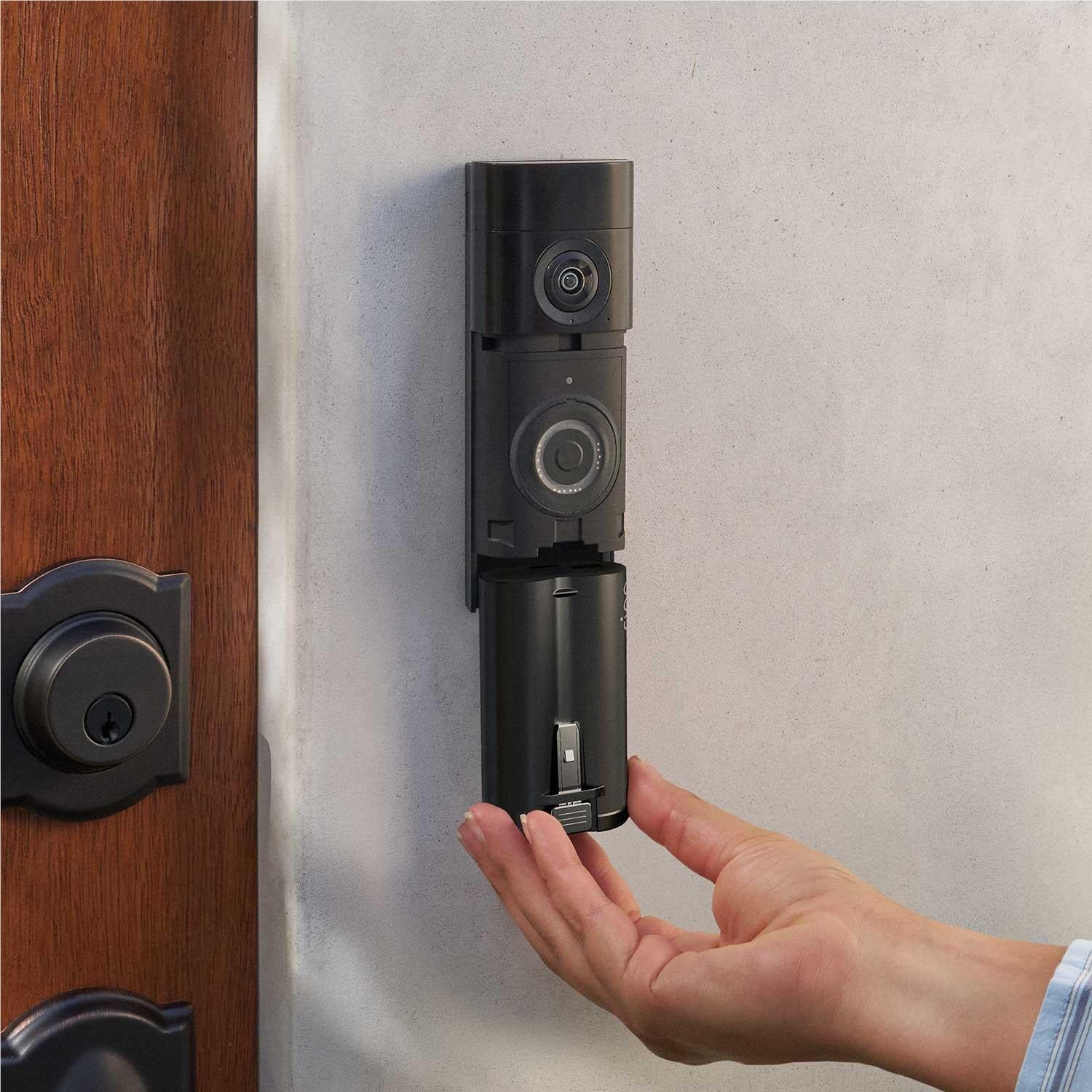 Ring quick release battery pack installed in doorbell housing, hand near latch