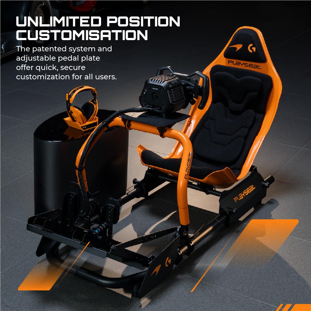 Orange and black racing simulator seat with steering and pedal base system