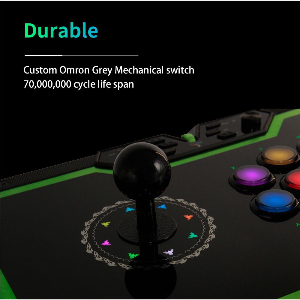 Black arcade fight stick with green accents, joystick center and multicolor illuminated buttons