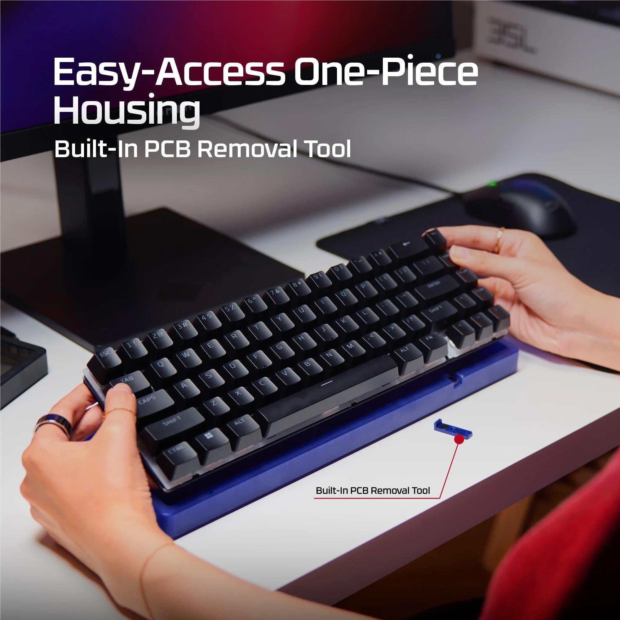 Black keyboard on a base with a hand removing a key using a removal tool