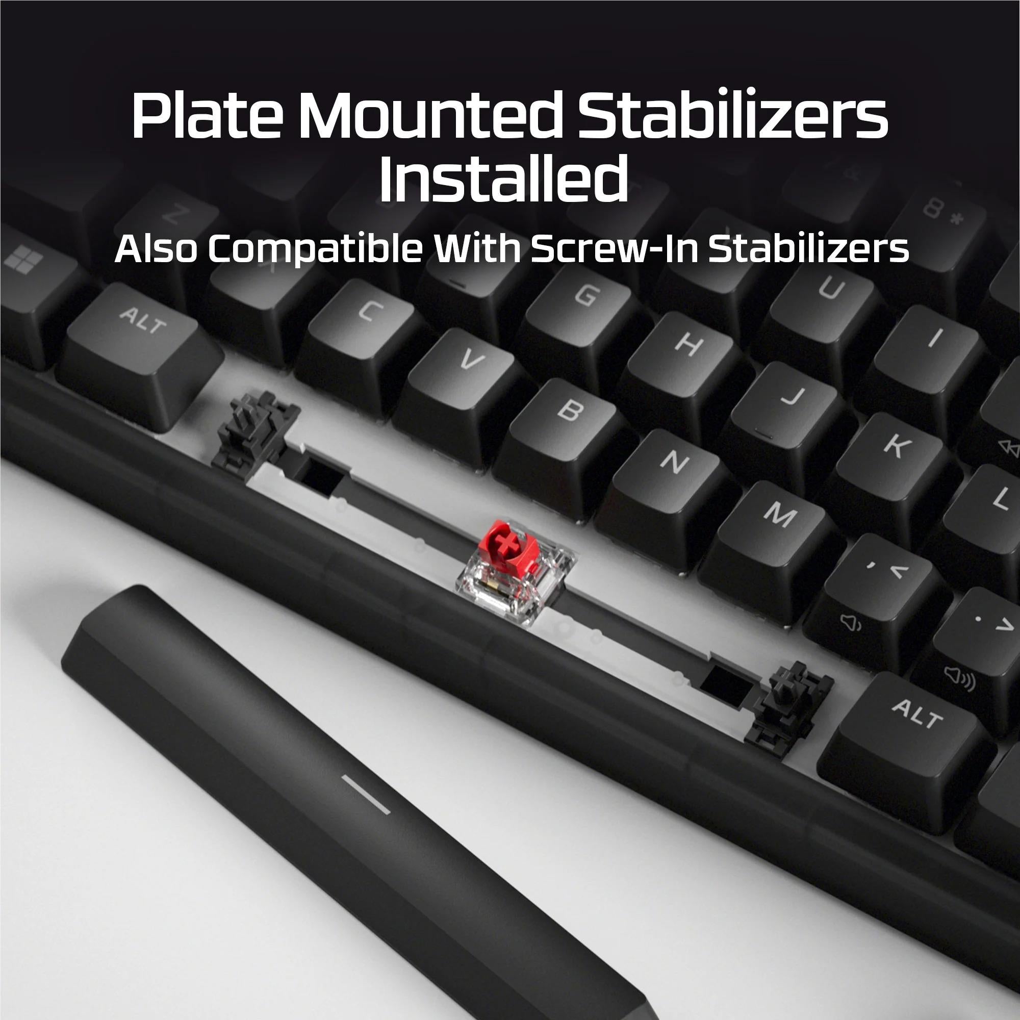 Keyboard close-up showing plate-mounted stabilizers with a red switch installed
