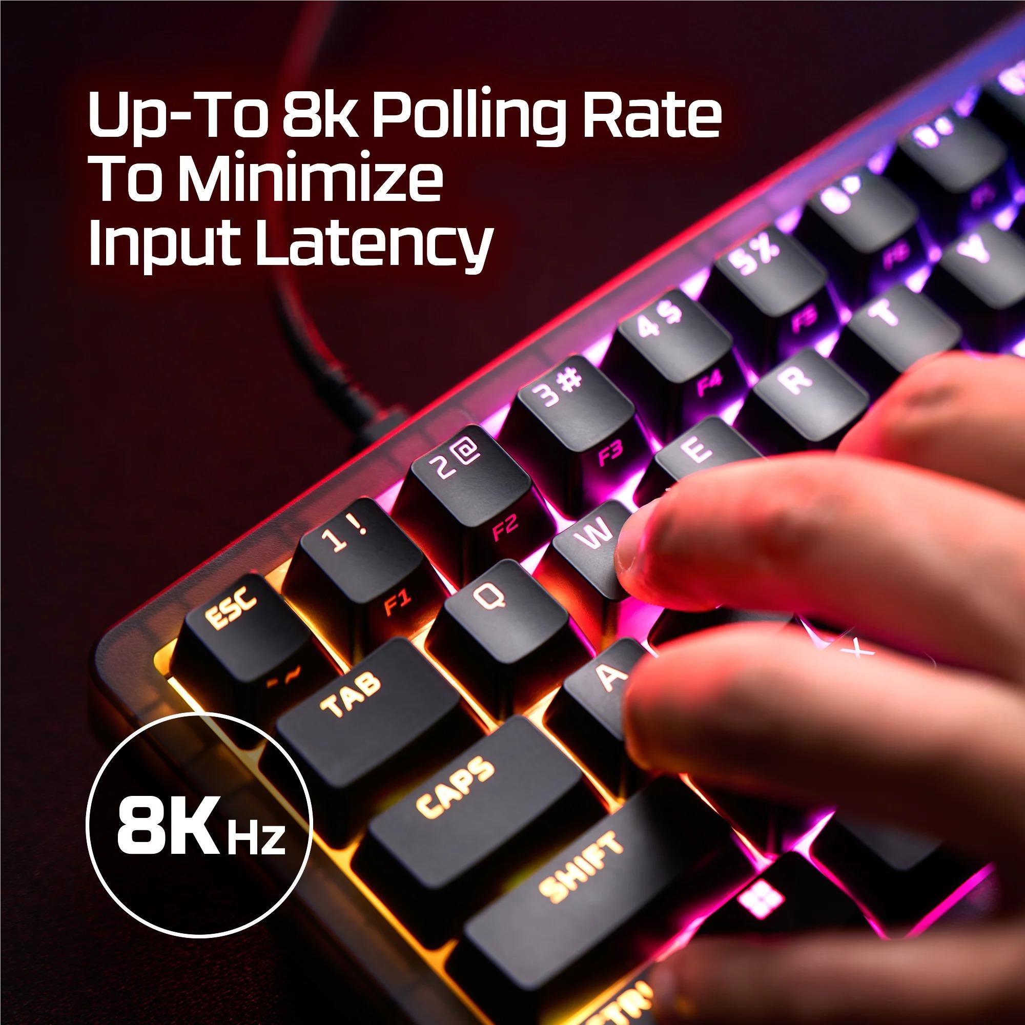 Close-up of keys with colorful RGB lighting while a finger presses a key