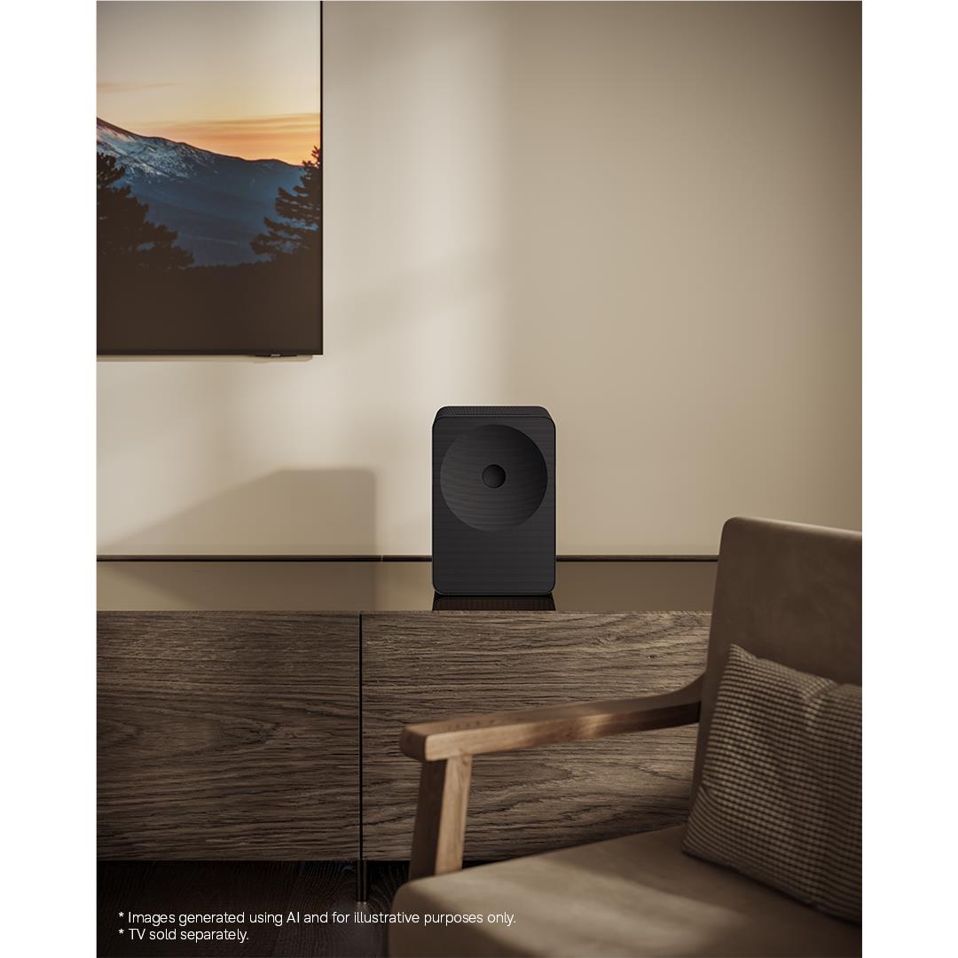 Black Wi‑Fi sound speaker with circular driver, standing on table