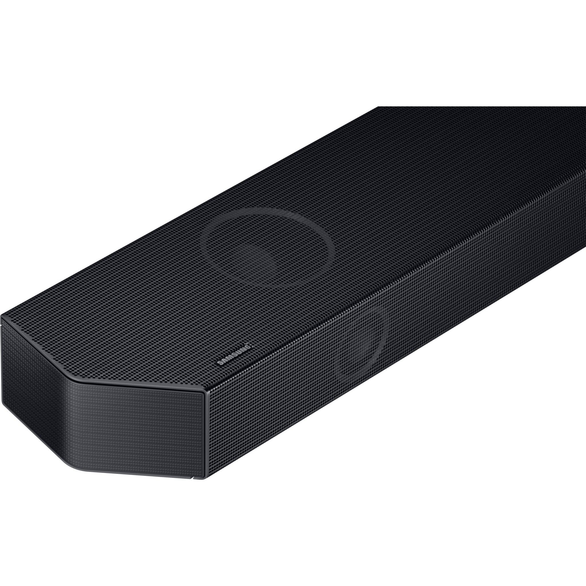 Black soundbar front corner close-up, textured grille with large speaker ring
