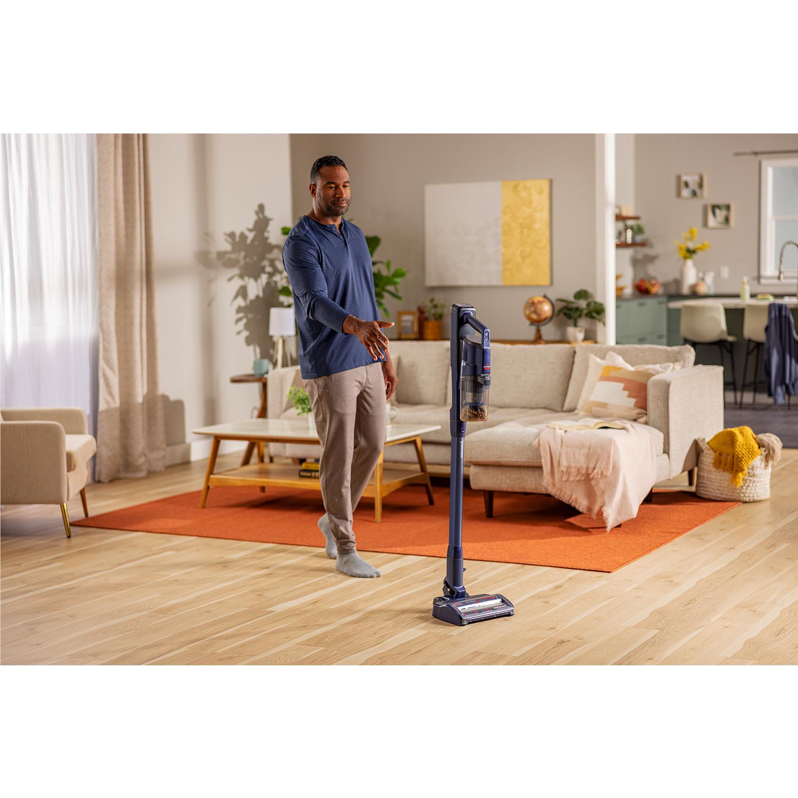 Bissell PowerClean cordless stick vacuum standing upright with floor brush