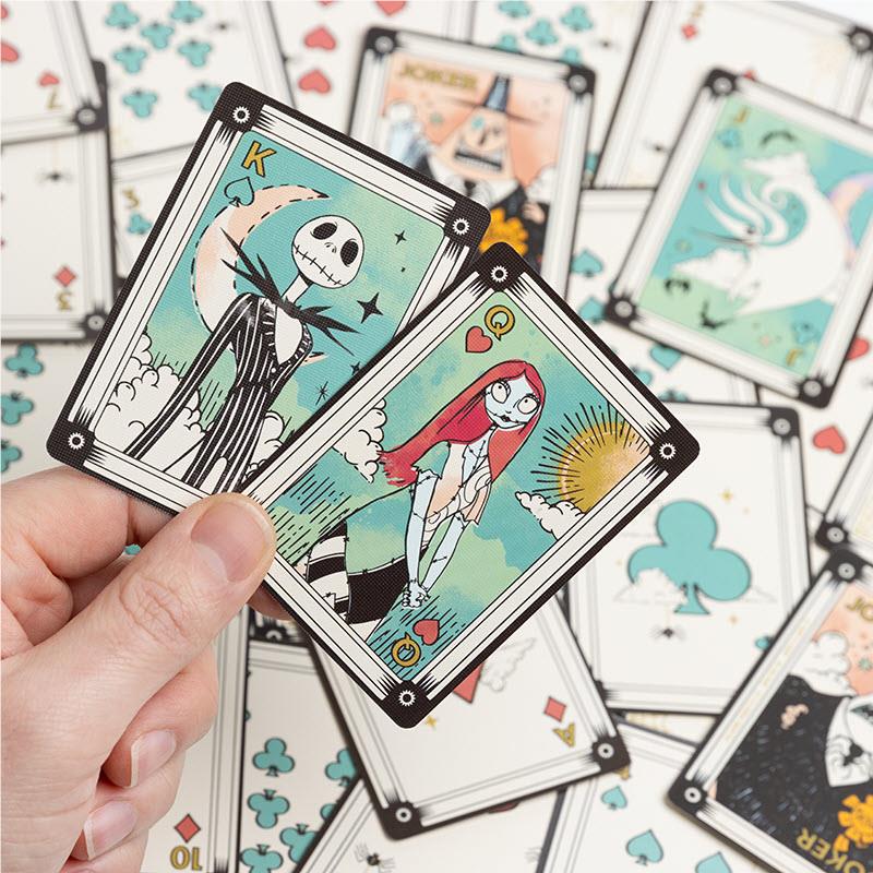 Hand holding a Nightmare-themed card; several card backs and faces around it