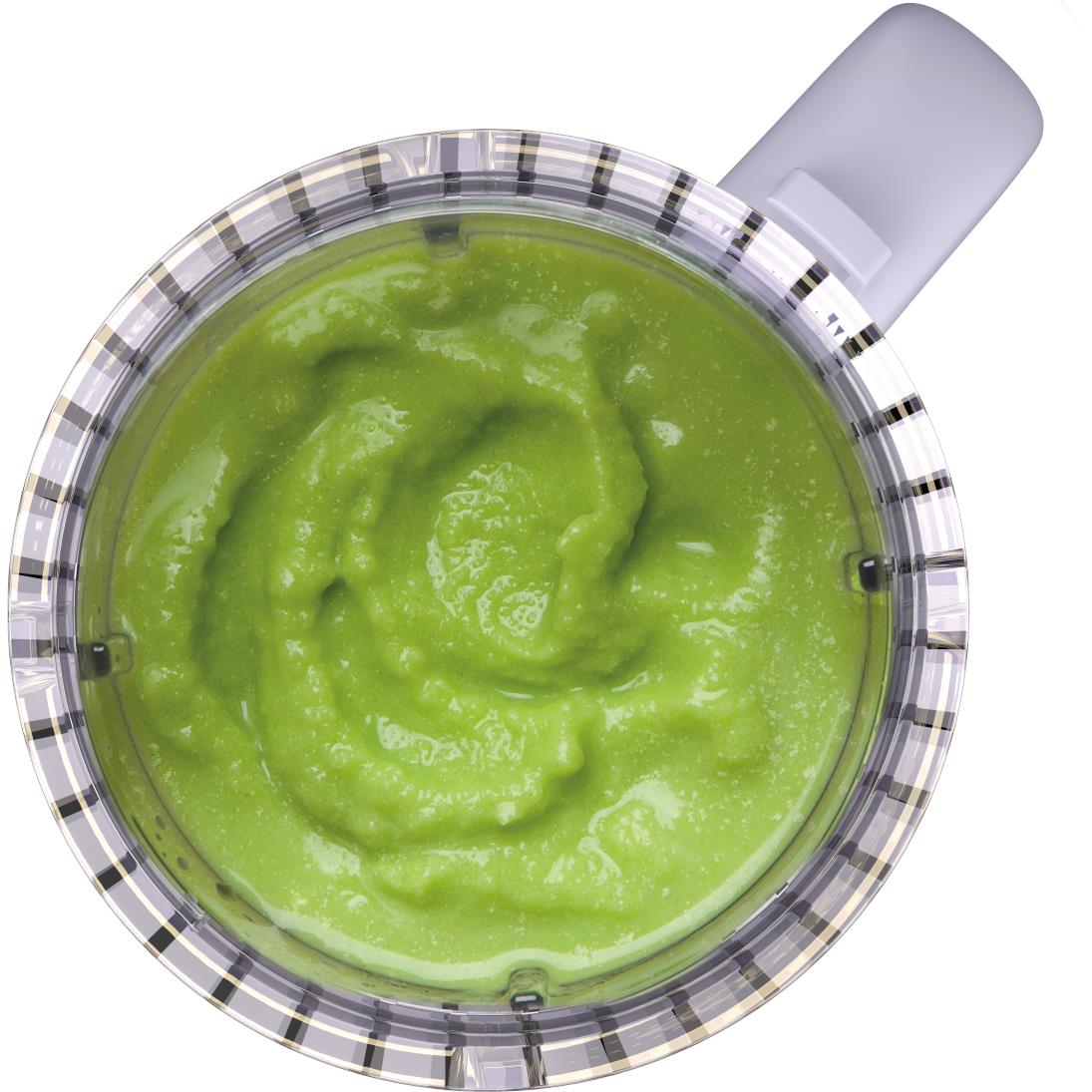 Transparent blender jar filled with green smoothie, viewed from above