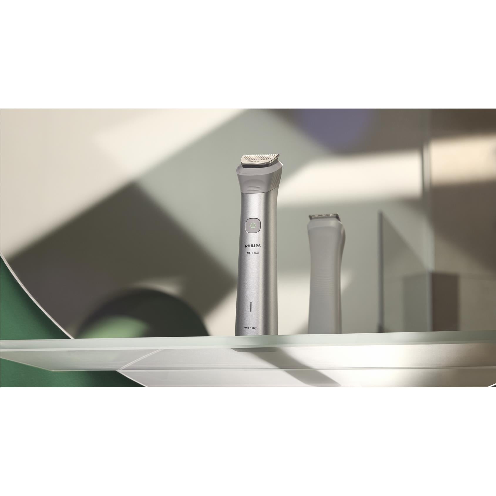 Cordless multigroomer with metal trimmer head and spare attachment