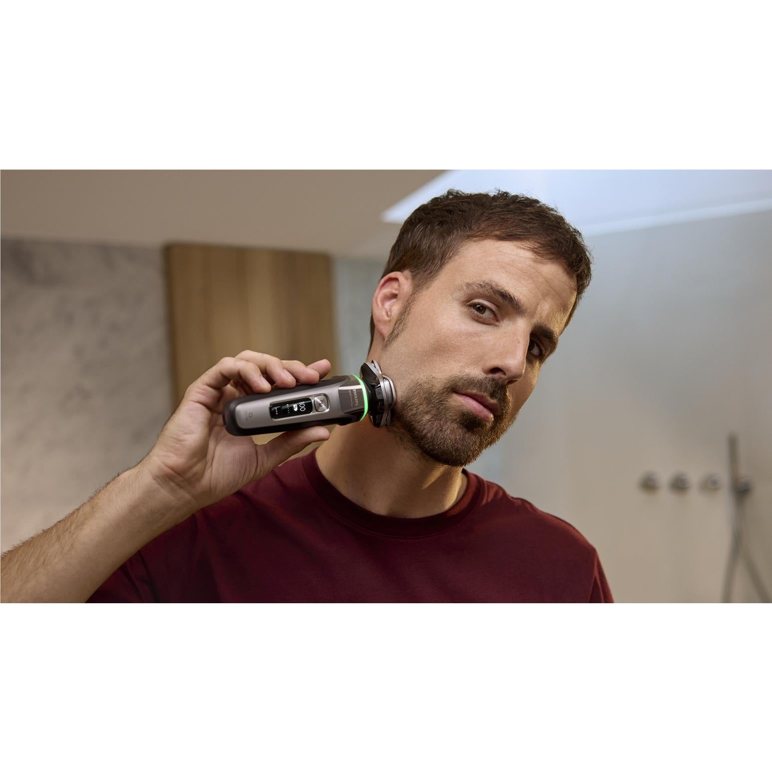 Electric shaver with foil head, being used on face