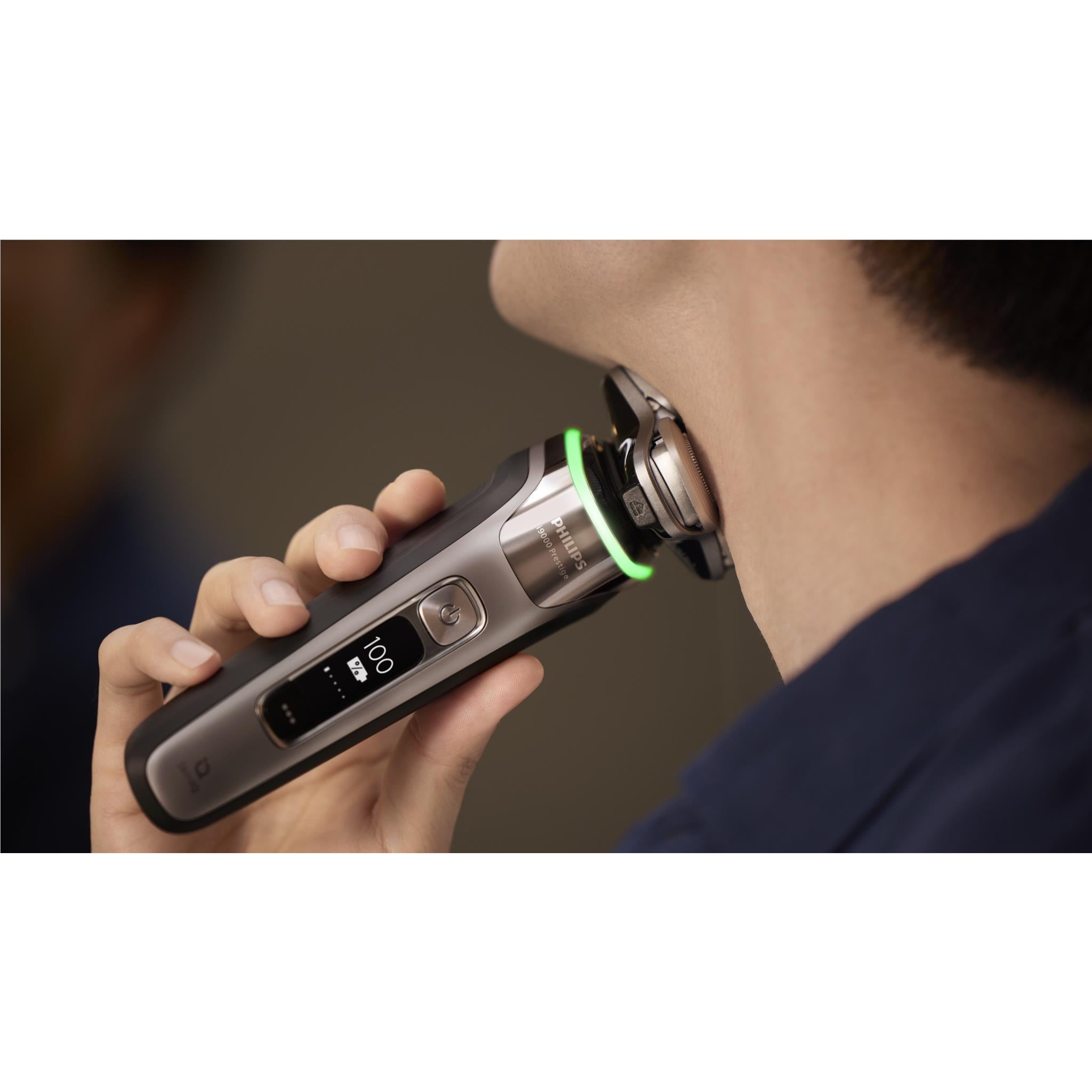 Electric shaver in use against the neck