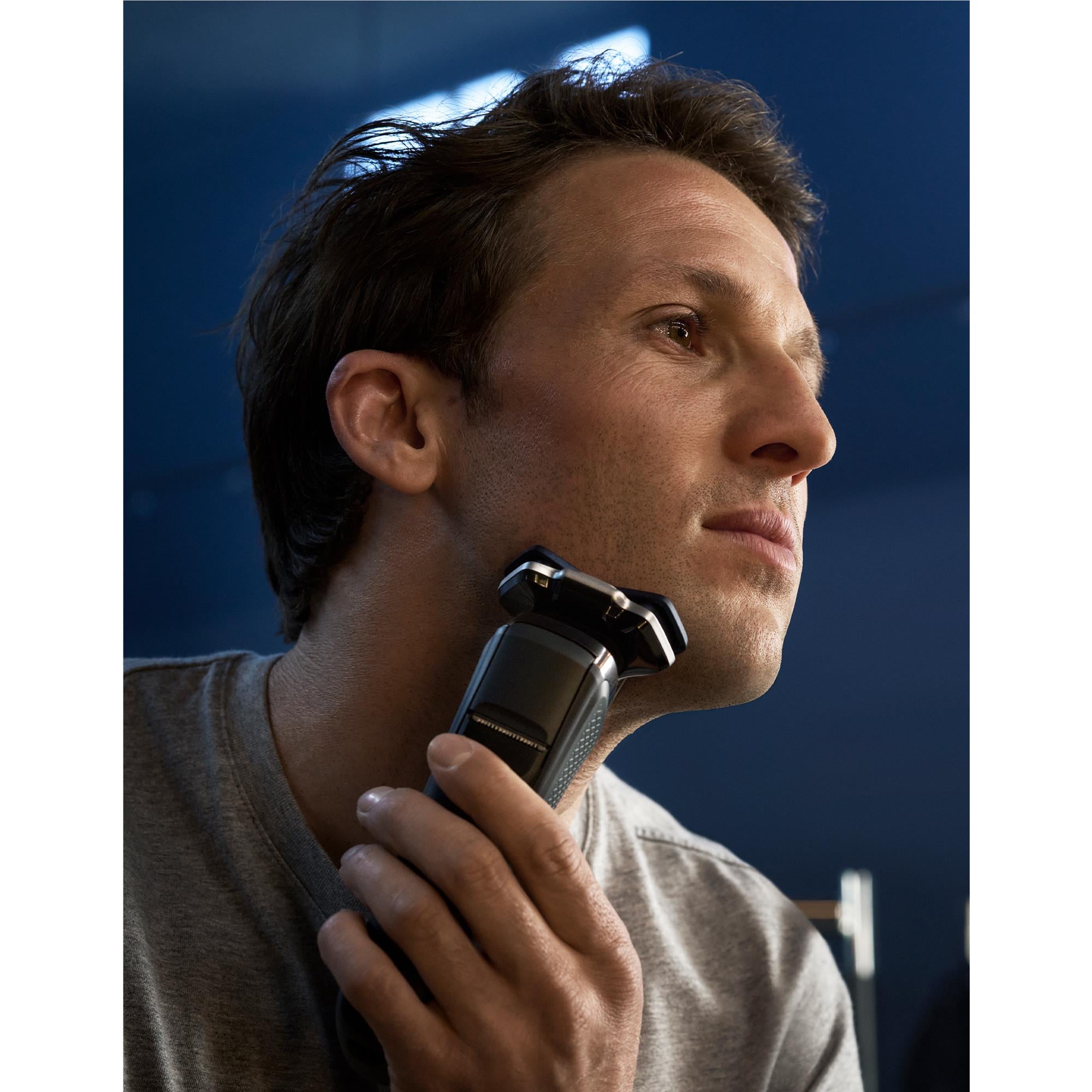 Handheld electric foil shaver being used on the jawline