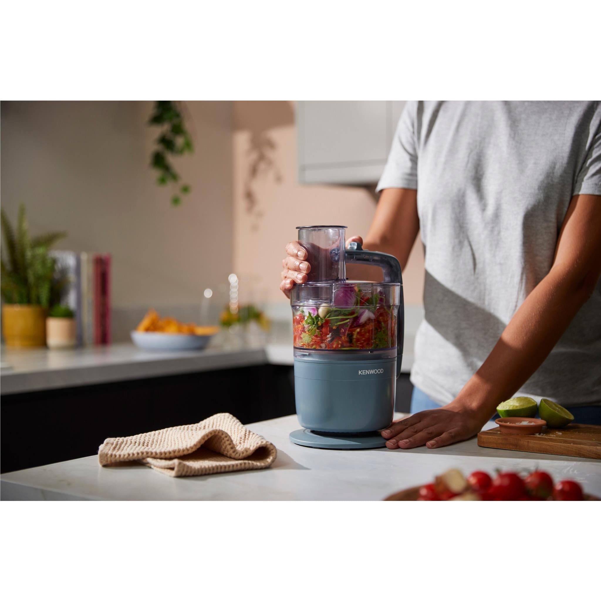 Storm Blue food processor with transparent jar containing chopped vegetables