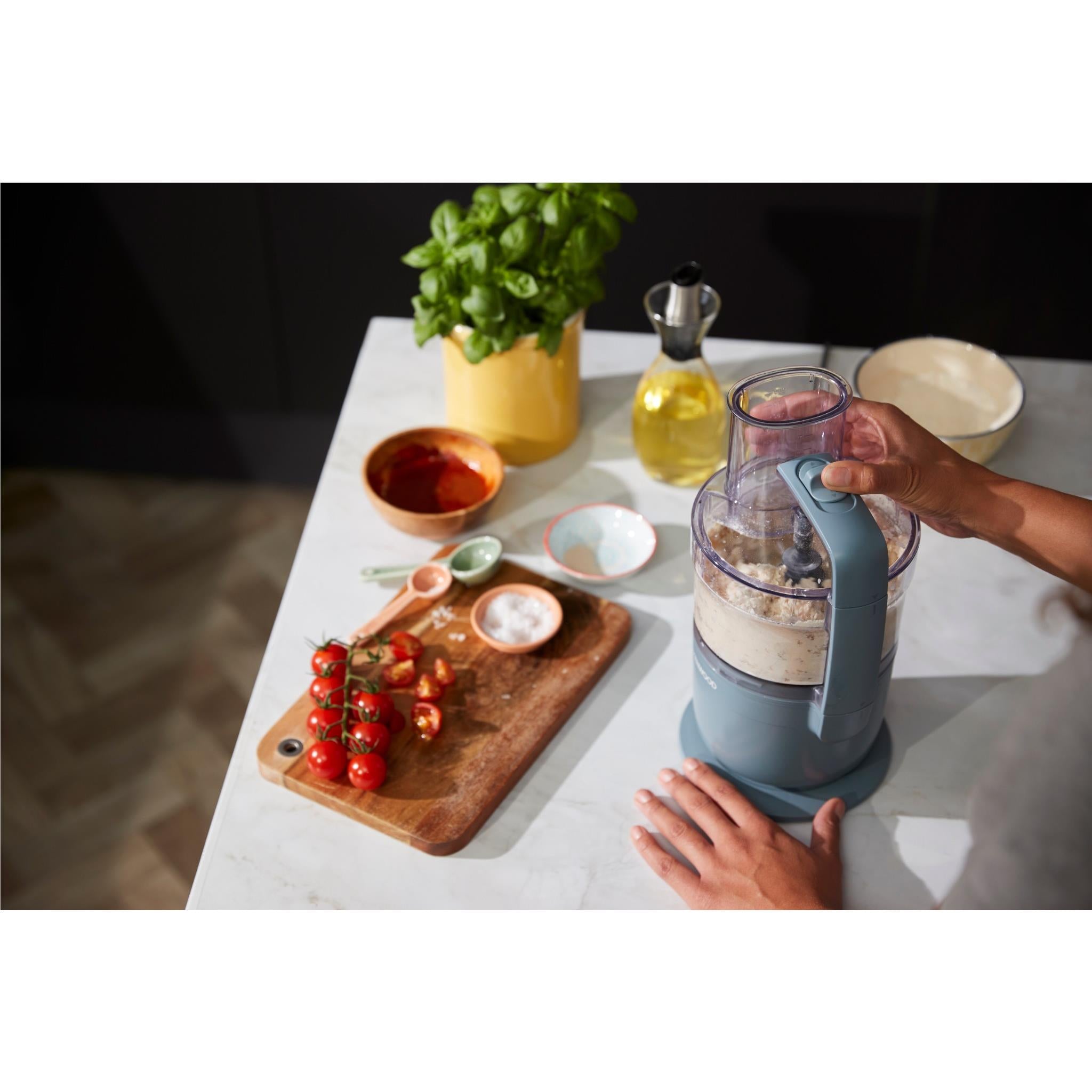 Storm Blue food processor on counter with ingredient bowl and control lid