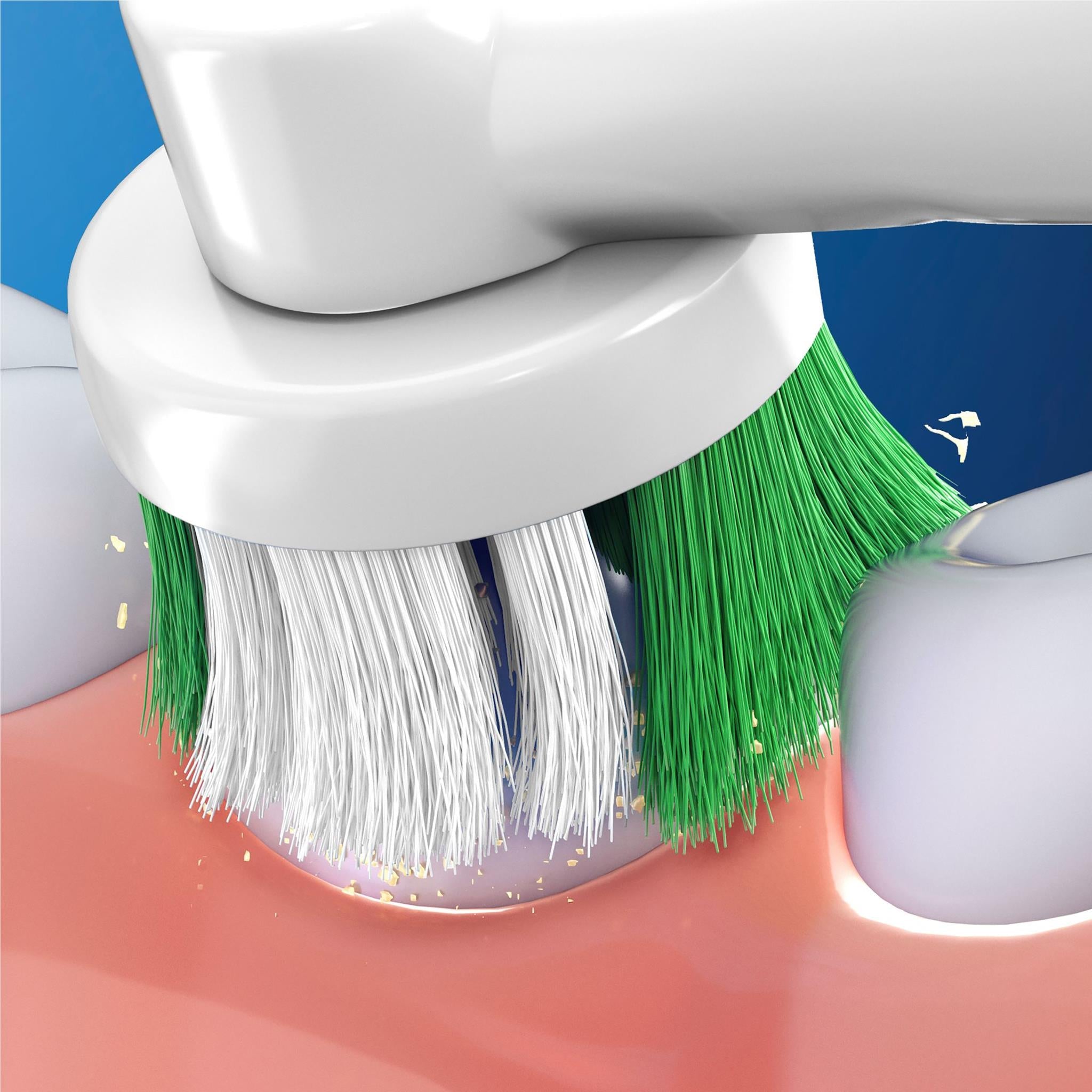Close-up of rotating toothbrush bristles cleaning gums and teeth