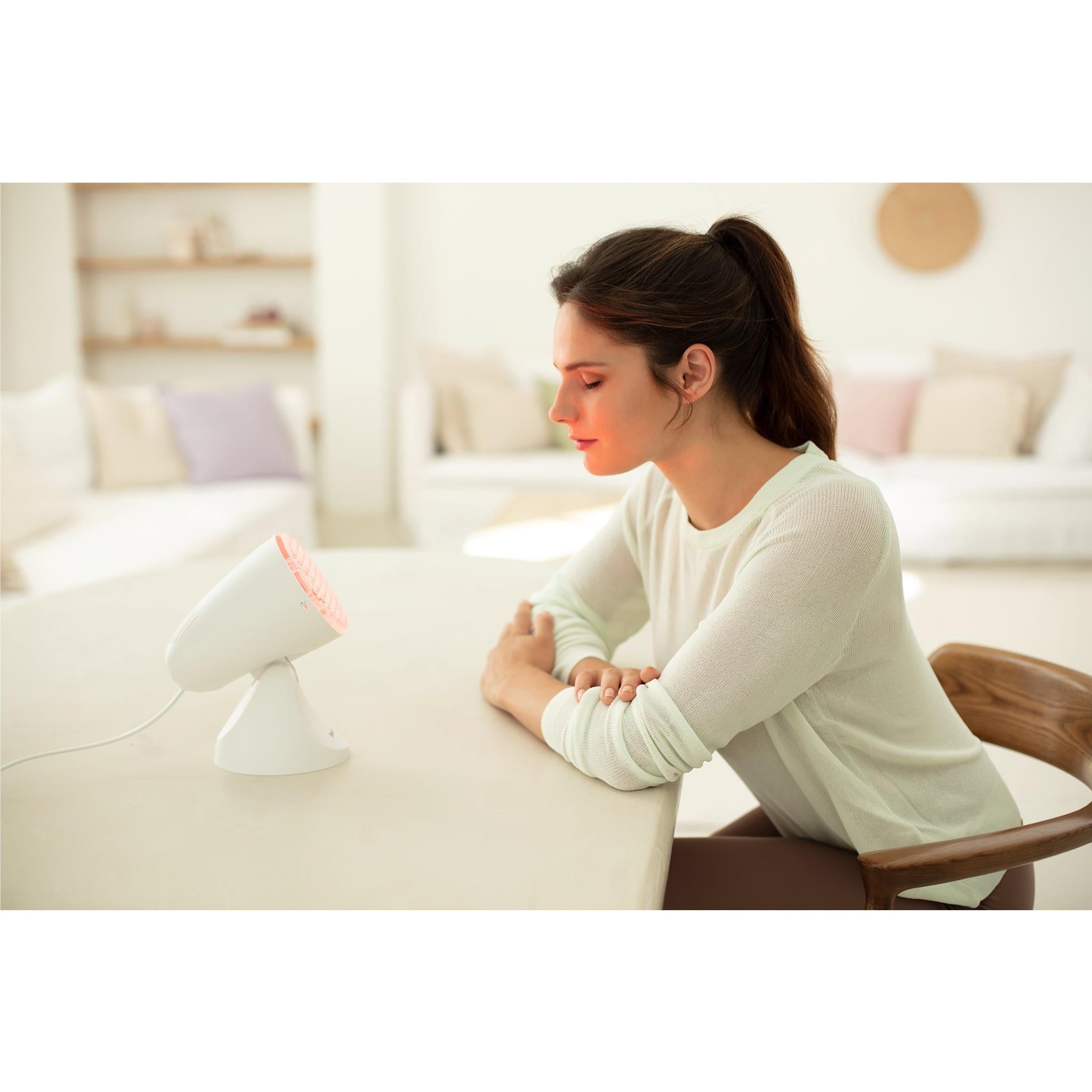 Beurer infrared heat lamp with red grille used for soothing on resting arm