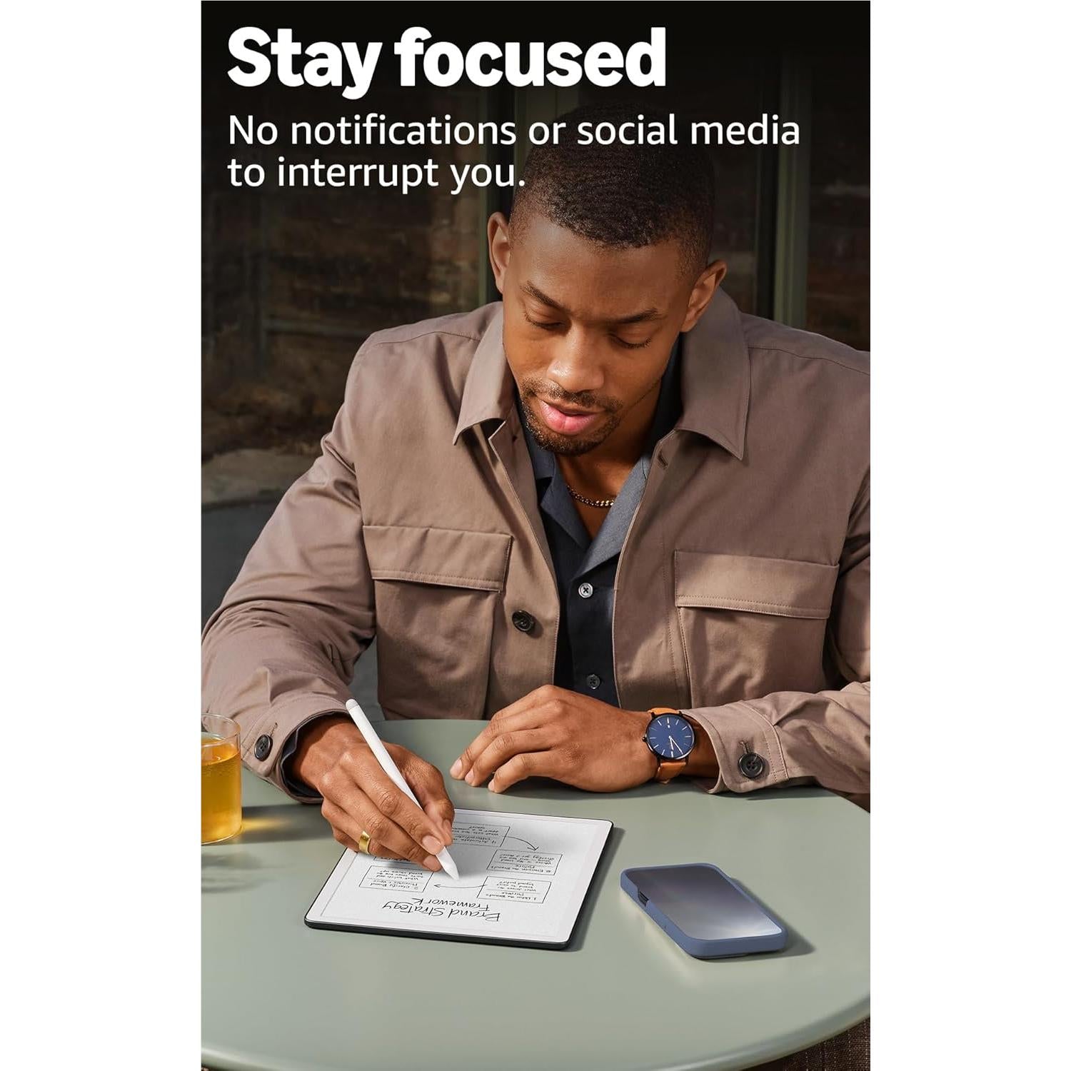 Amazon Kindle Scribe 11-inch notebook on desk, man writing with stylus