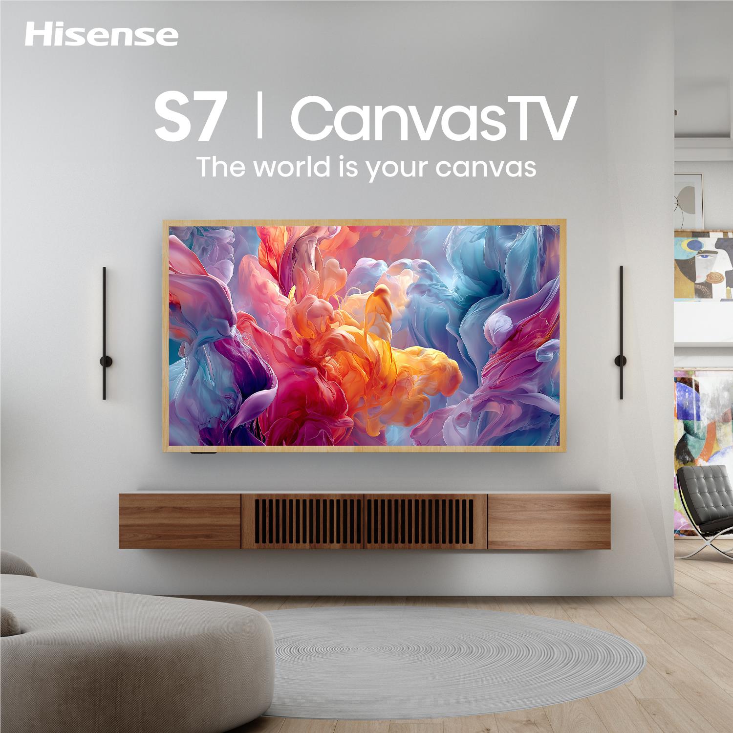 Wall-mounted CanvasTV with colorful abstract artwork on a slim wood frame.