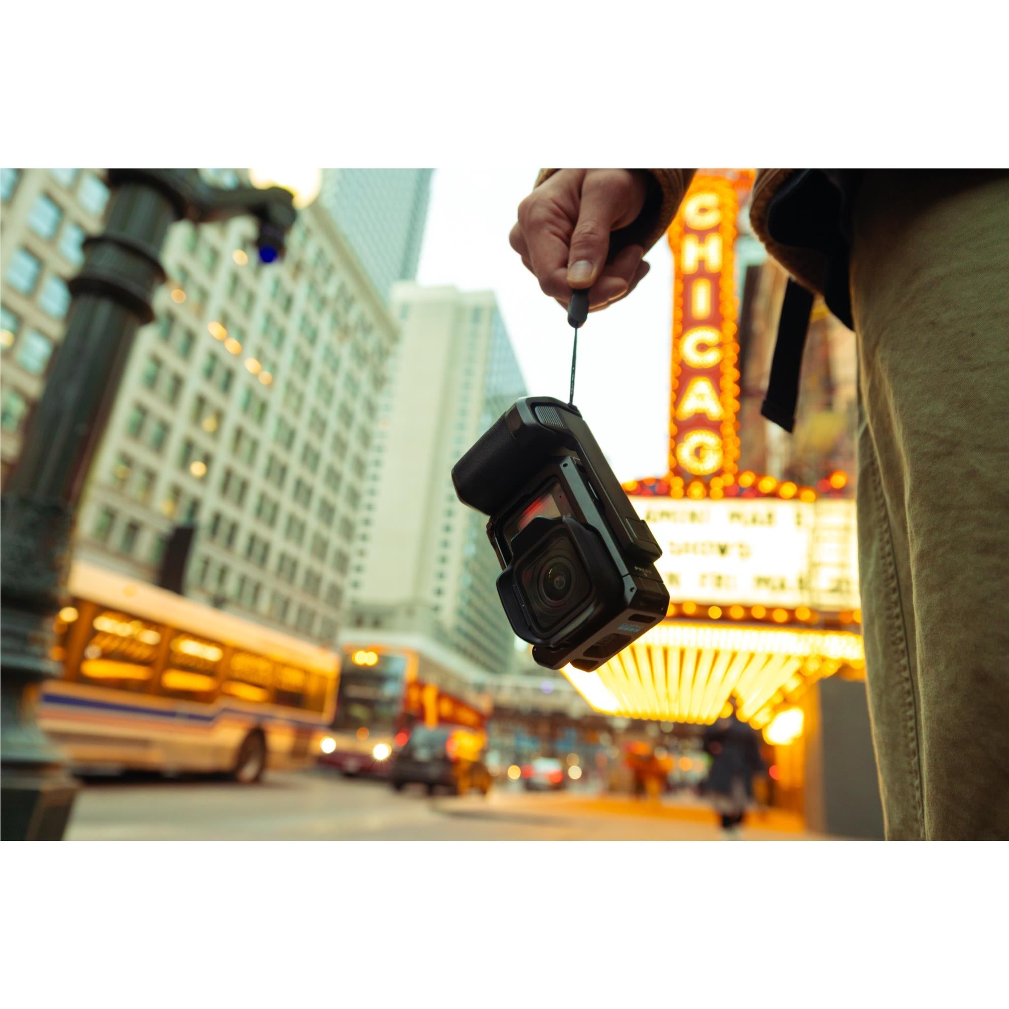 GoPro camera grip with cold shoe mount, hand holding black action camera