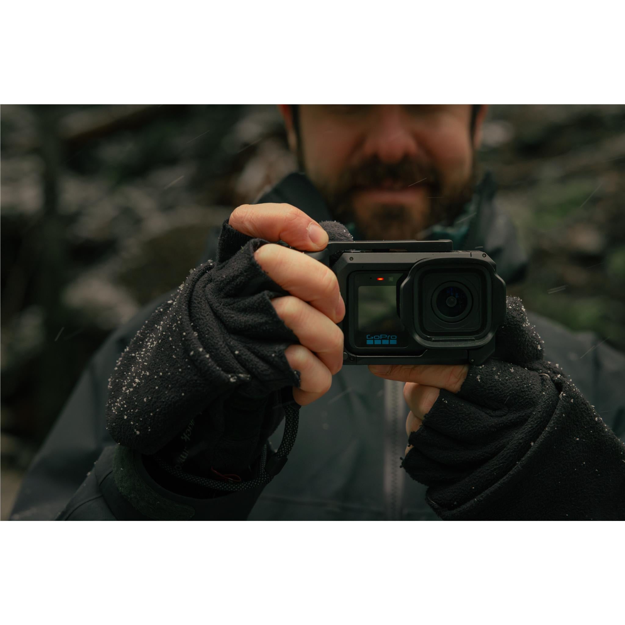 GoPro camera grip with cold shoe mount, person holding camera with hands in front