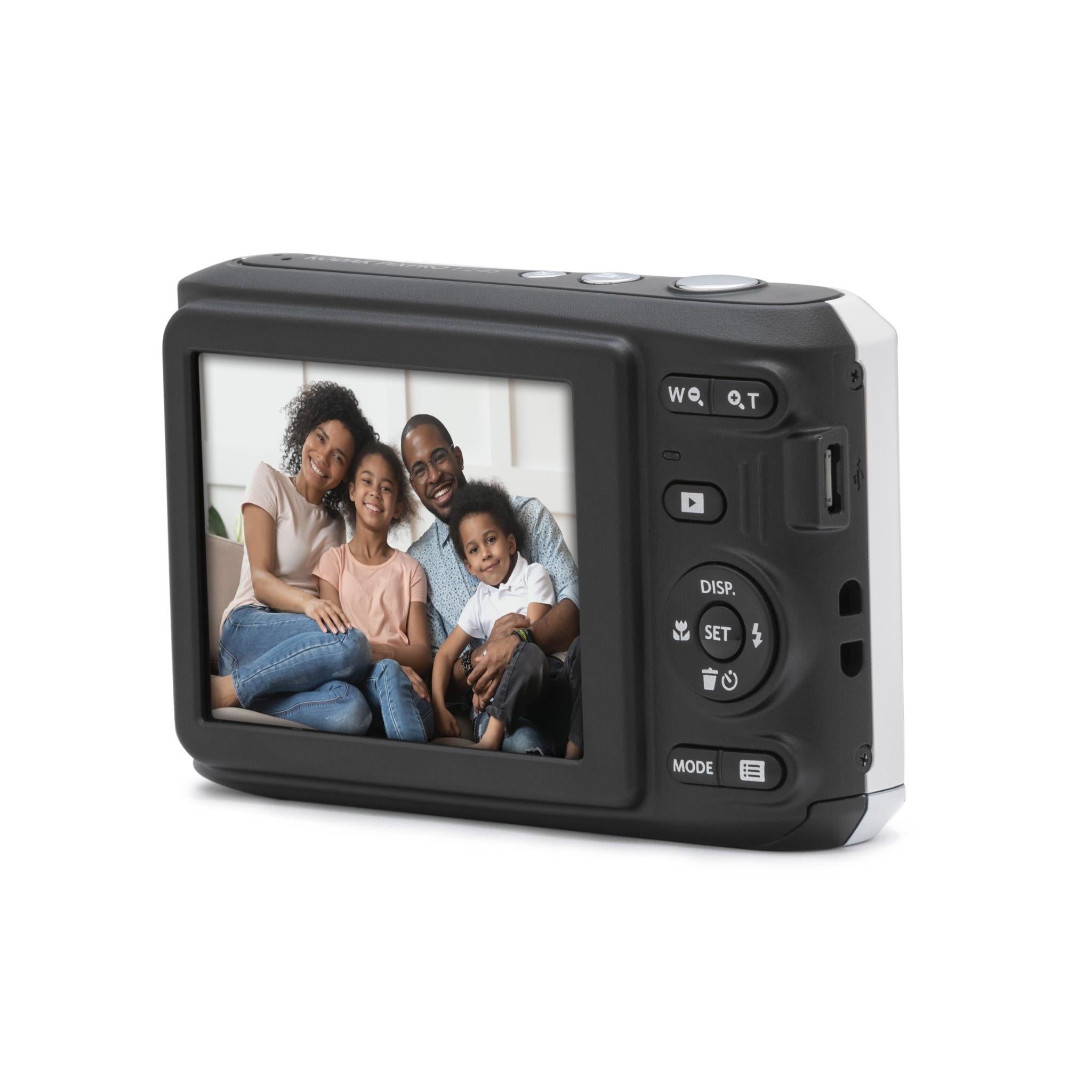 Front-leaning view of white compact digital camera with LCD showing a family group