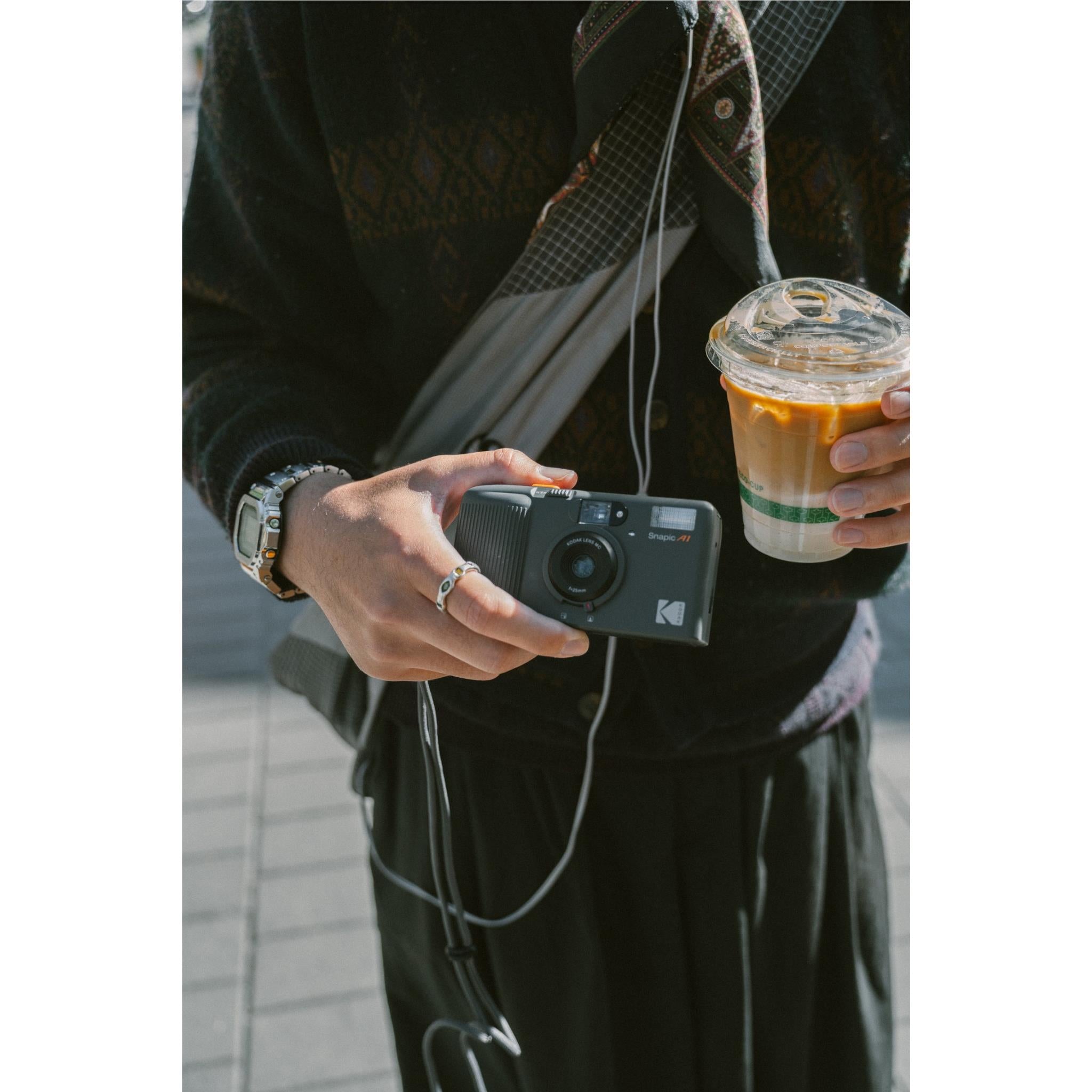 Hand holding Kodak Snapic A1 compact 35mm film camera with wrist strap