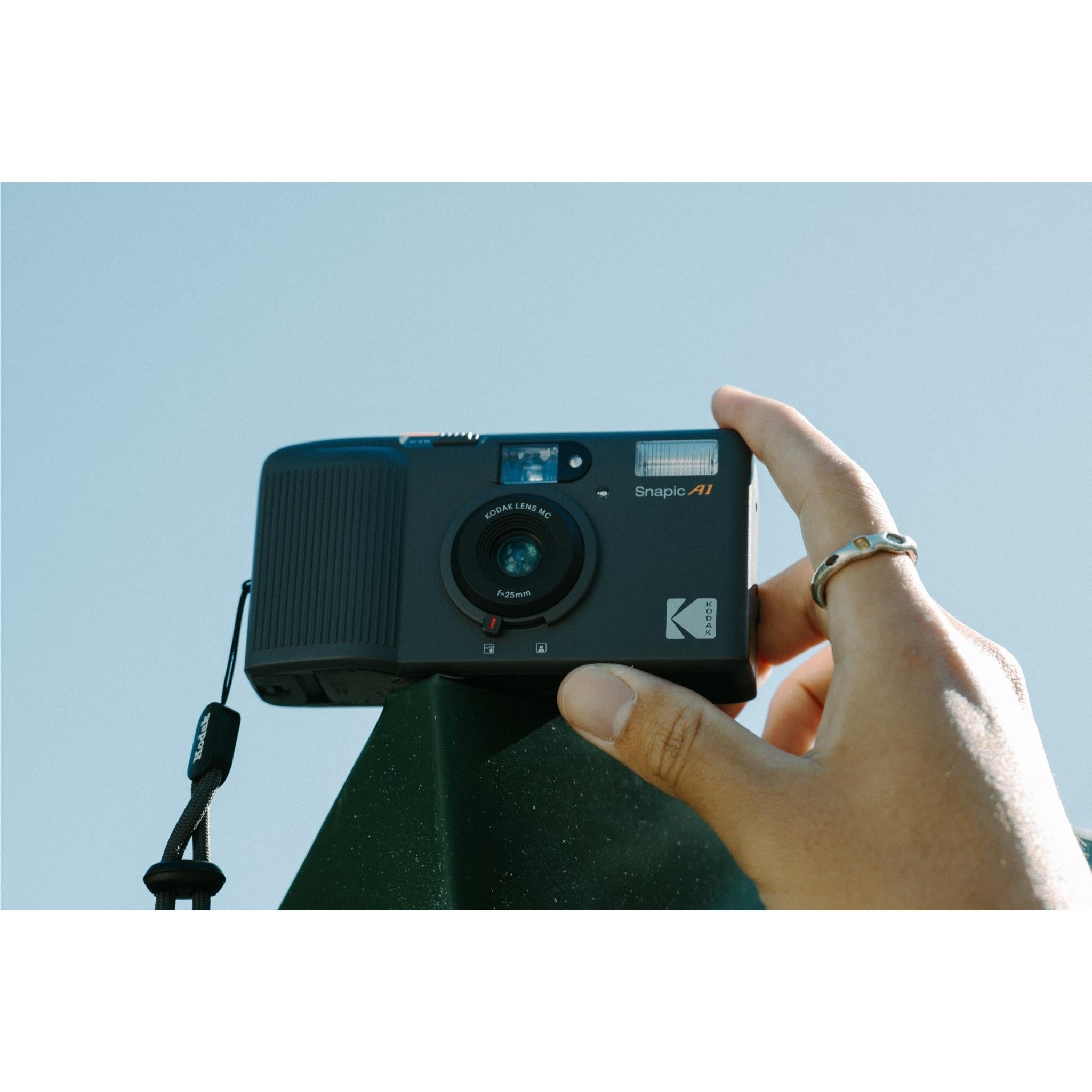 Kodak Snapic A1 compact 35mm film camera held near face with fingers on top