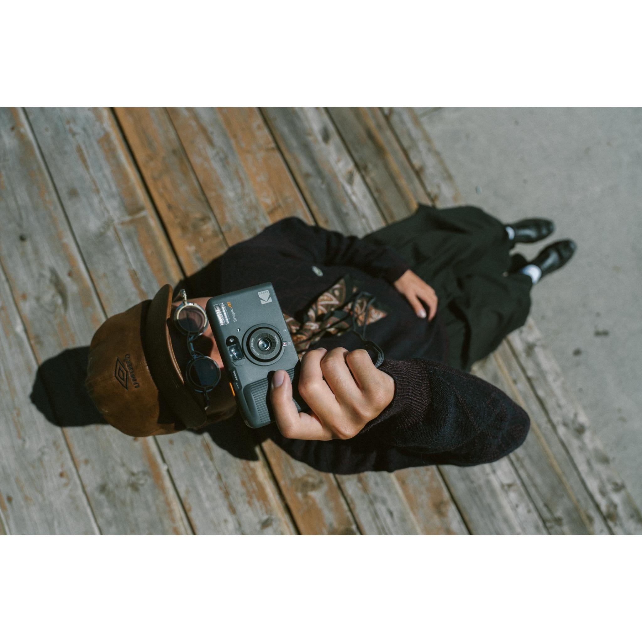 Person holding Kodak Snapic A1 compact 35mm film camera outdoors