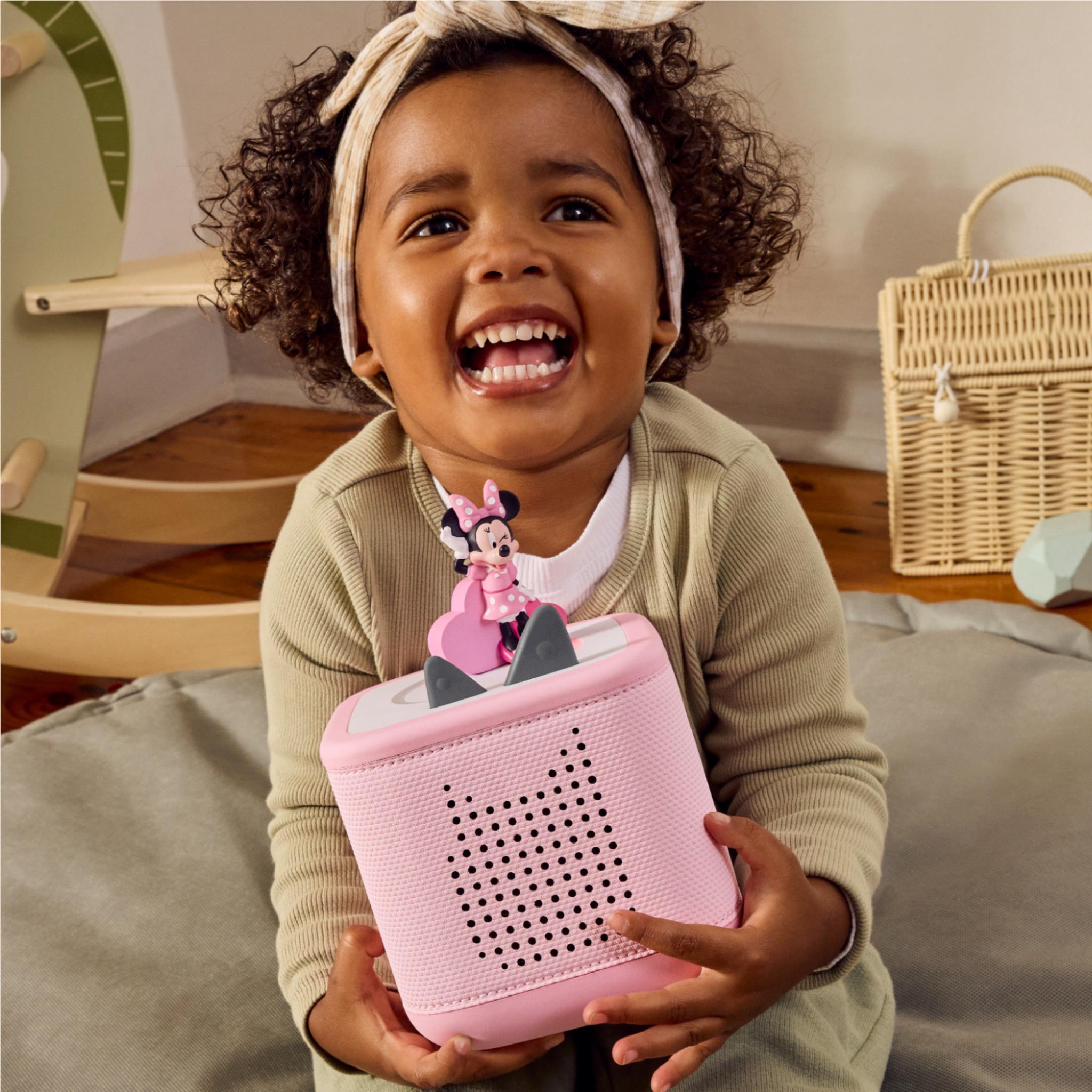 Pink Minnie Mouse audio Tonie figure held in a child’s hands
