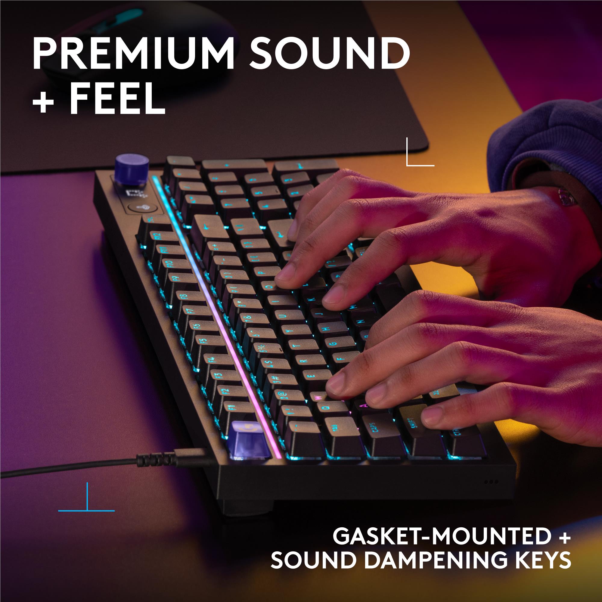 Black mechanical keyboard with RGB backlit keys and hands pressing keys