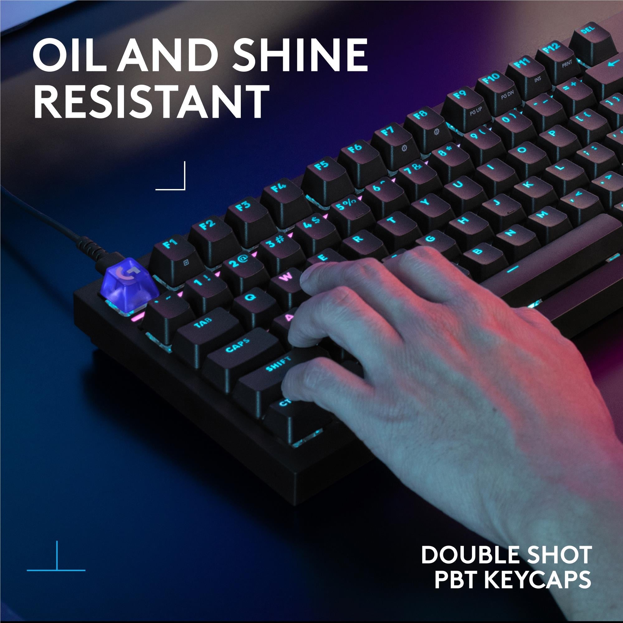 Black mechanical keyboard with RGB backlit keys and hand pressing PBT double-shot keycaps