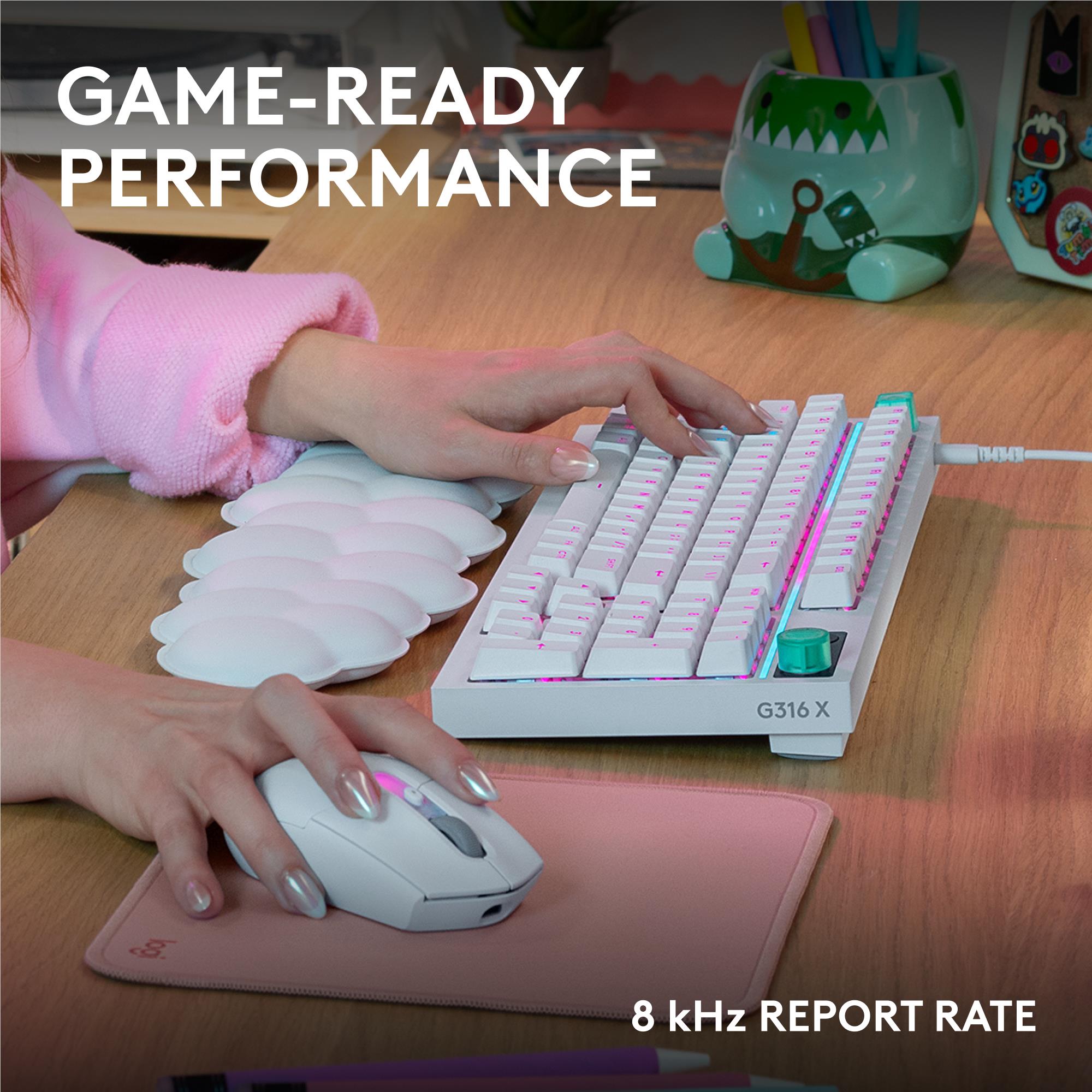 White wired gaming keyboard with RGB backlit keys being typed by hands